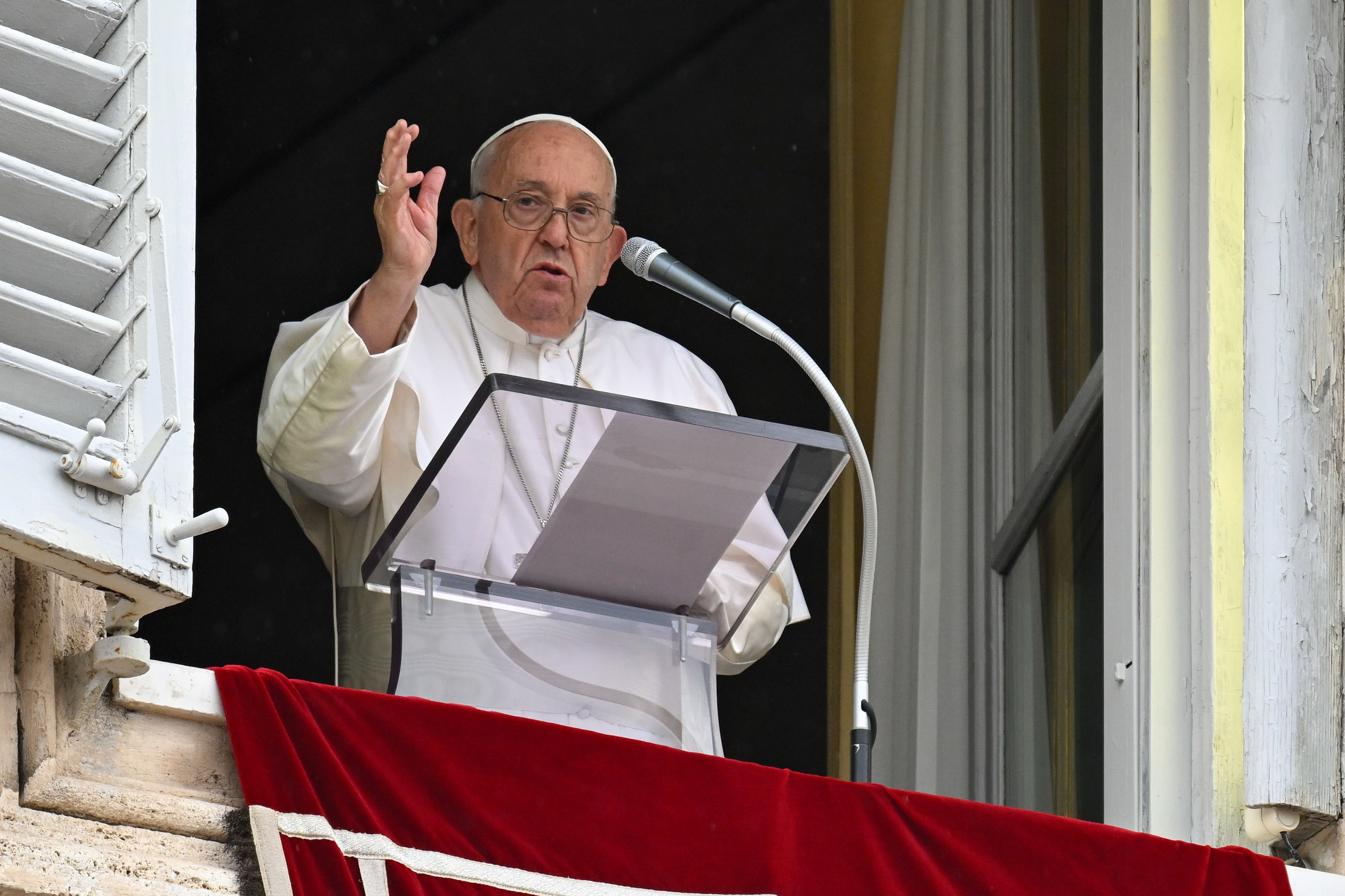 Pope Francis gives his blessing to visitors gathered in St. Peter's Square.