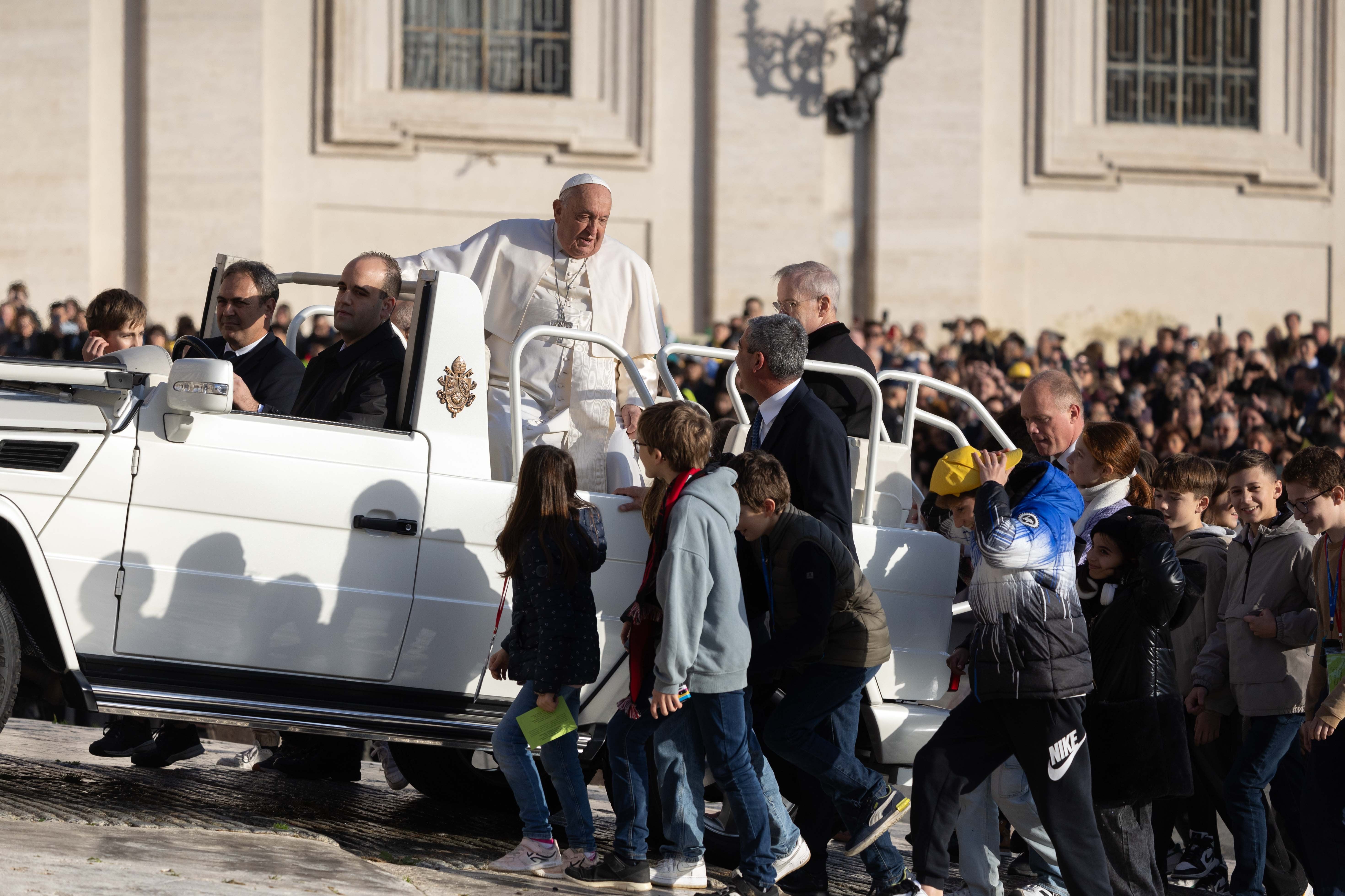 Pope Francis rides the popemobile in St. Peter's Square.