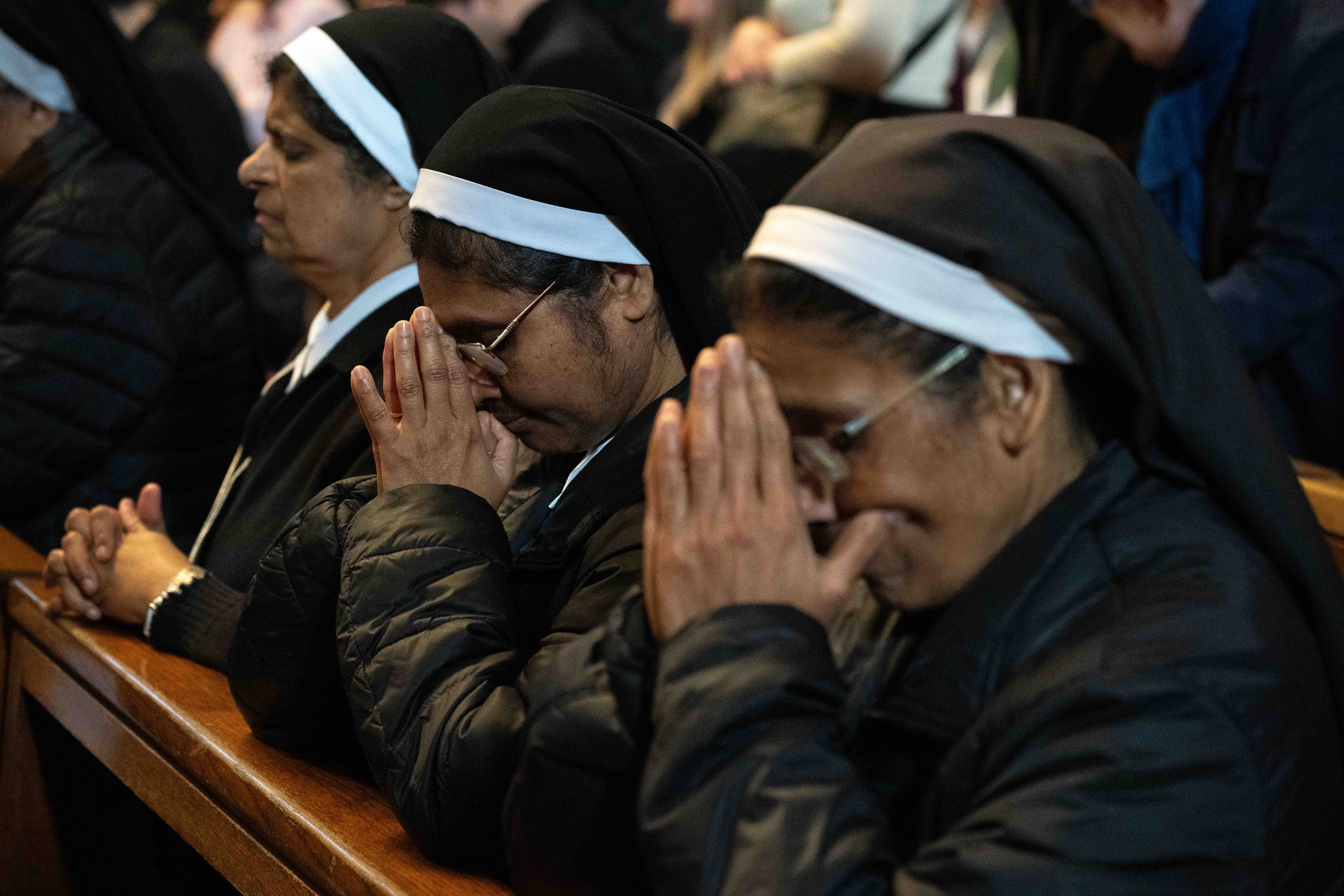 Religious women pray at Mass