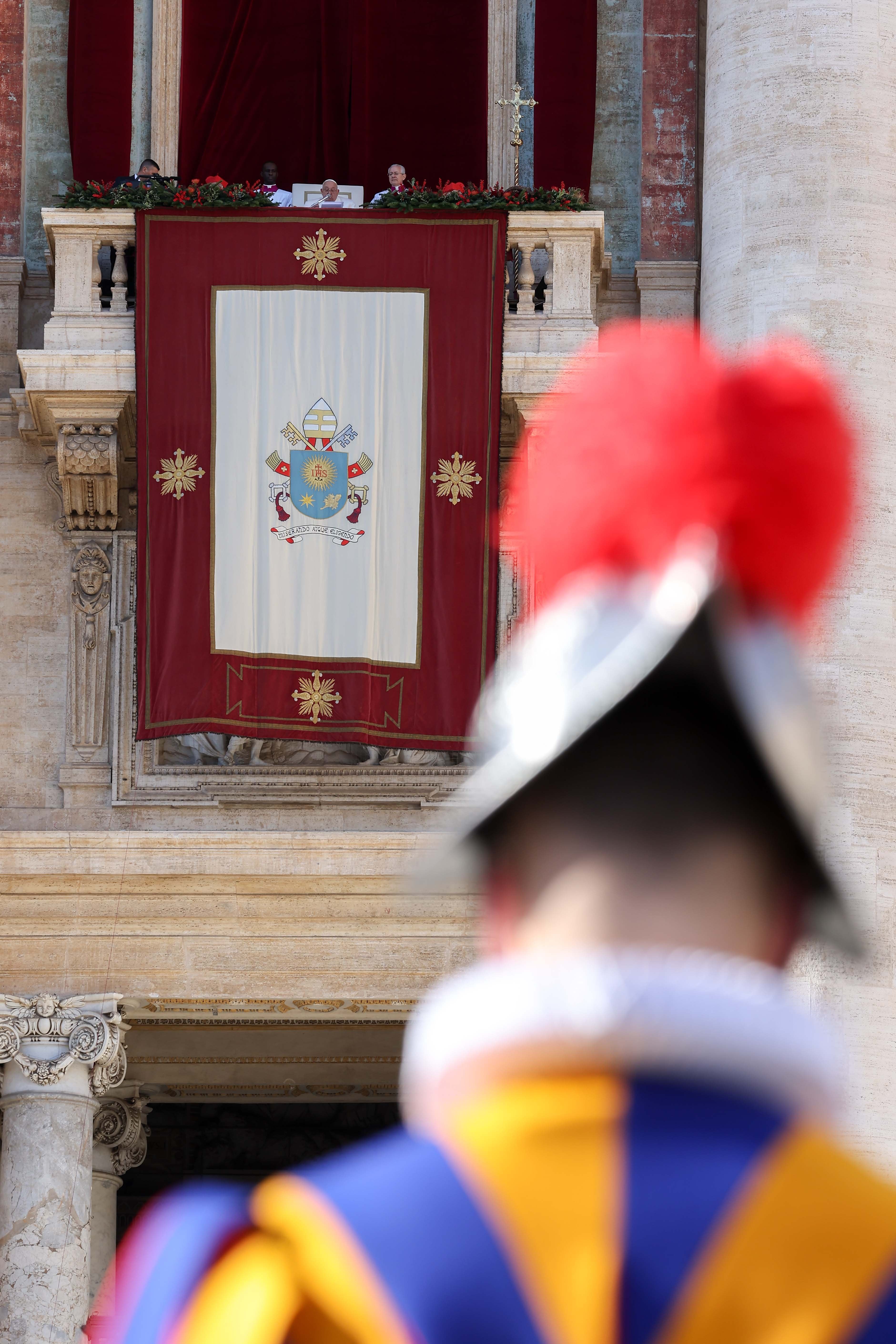 Pope Francis delivers his Christmas message from the central balcony of St. Peter's Basilica.