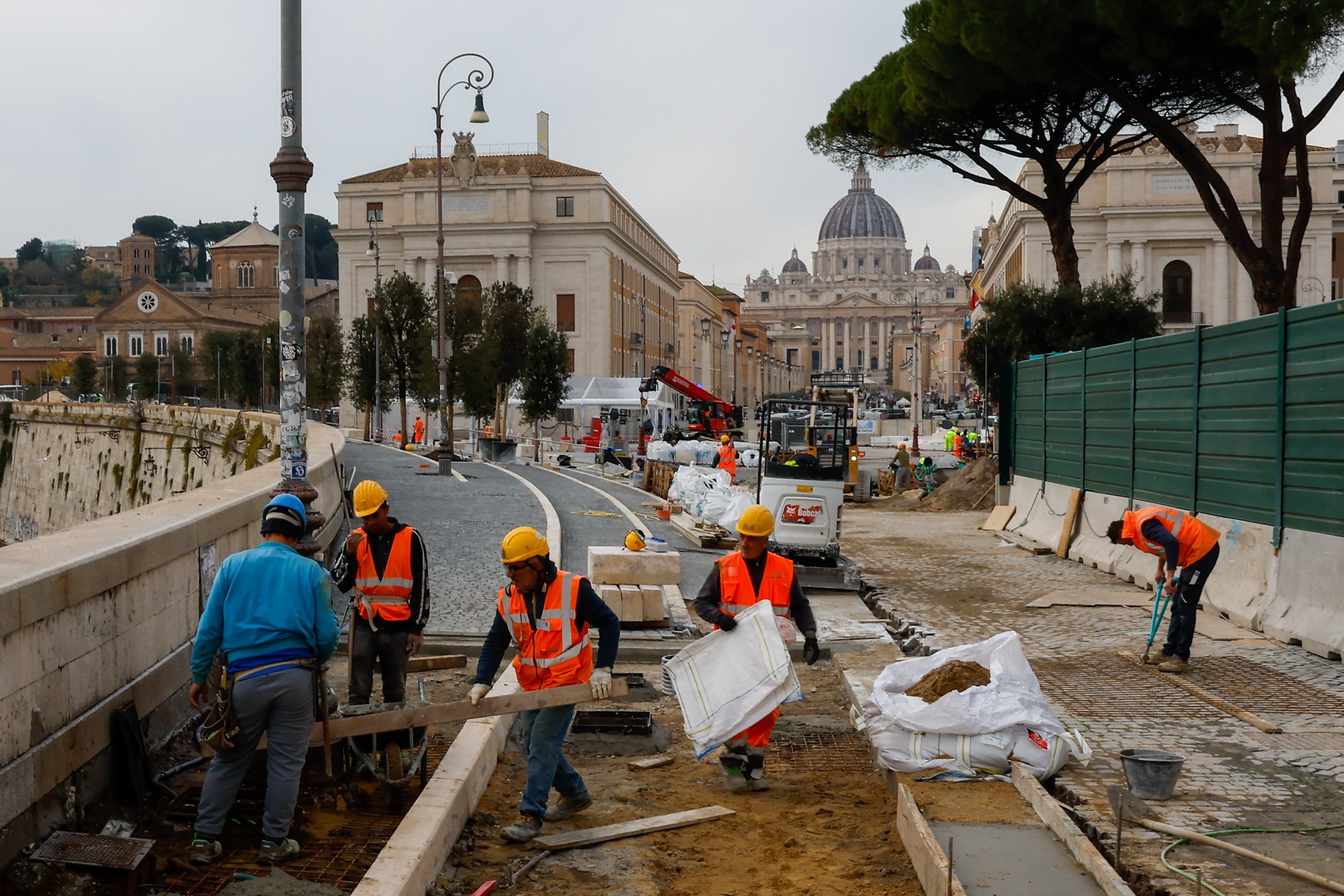 Workers set cobblestones in new pedestrian area by Vatican