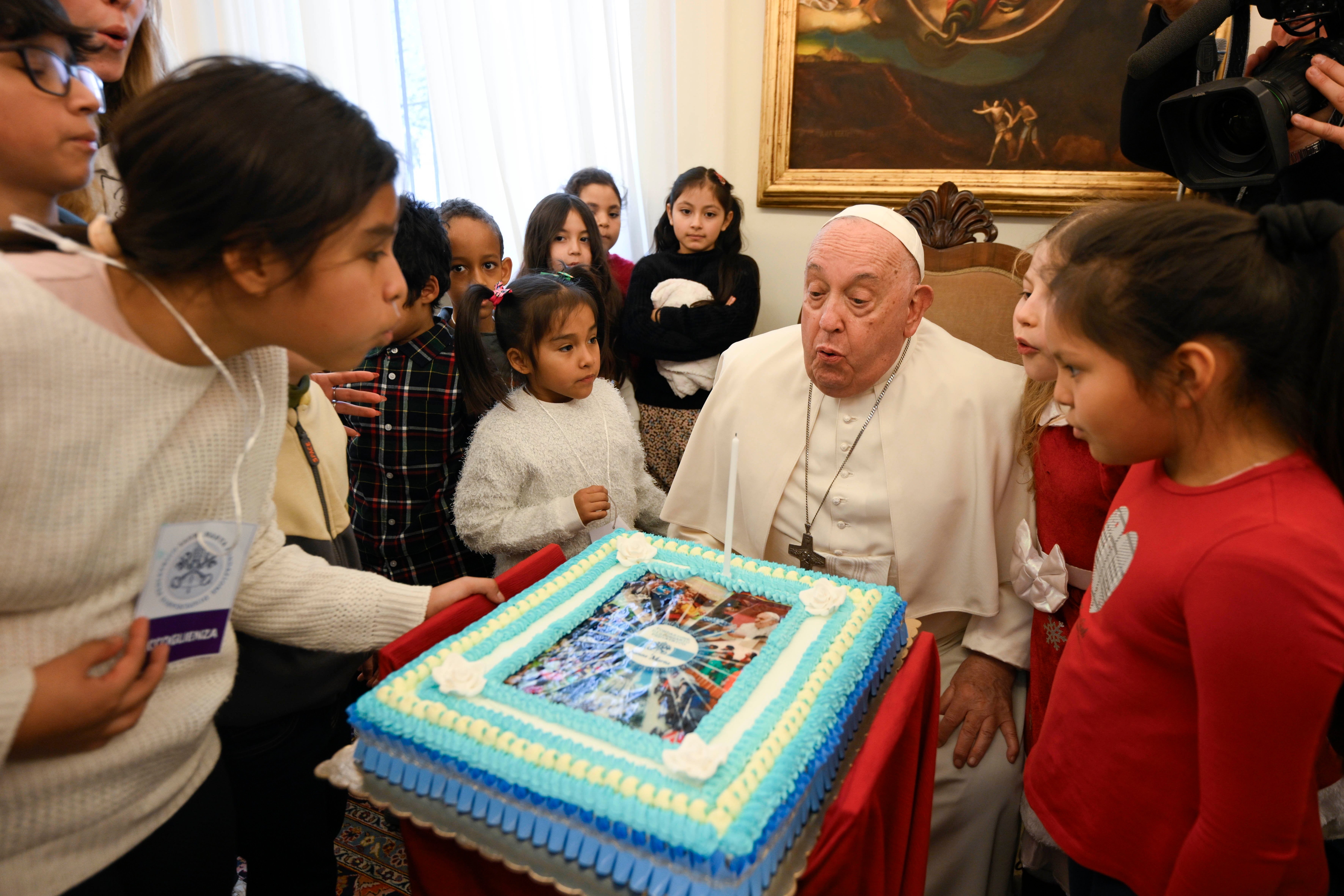 Pope Francis blows out candle on birthday cake