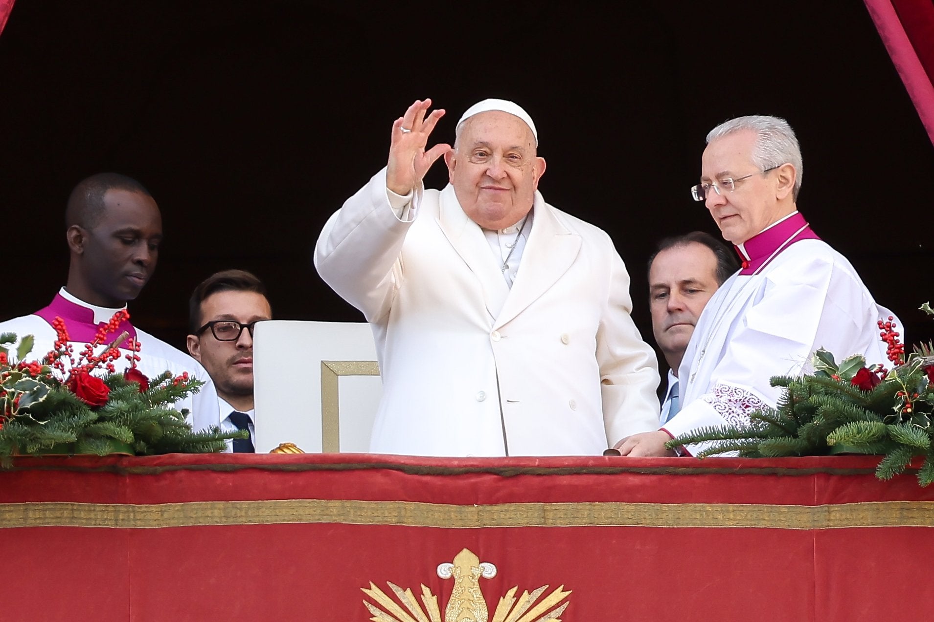 Pope Francis waves at the crowd on Christmas