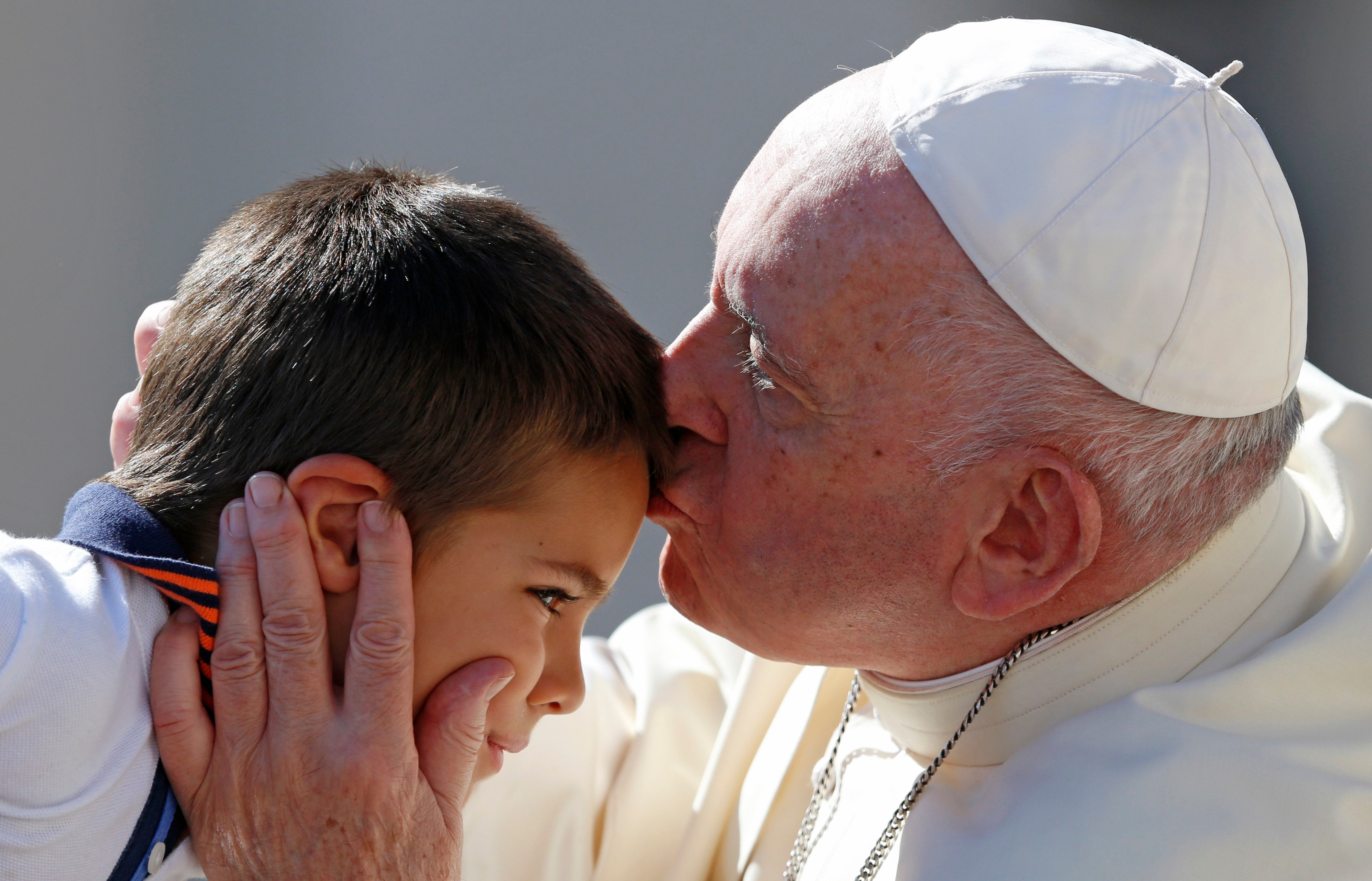 Pope Francis kisses a boy