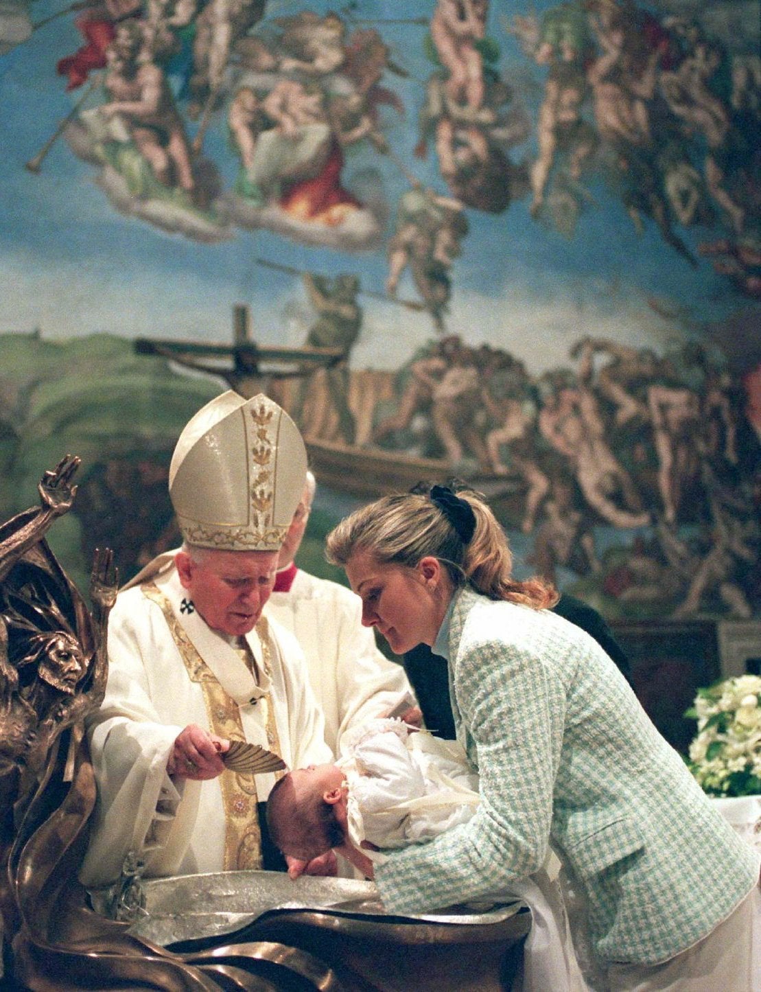 St. John Paul II baptizes a baby in the Sistine Chapel