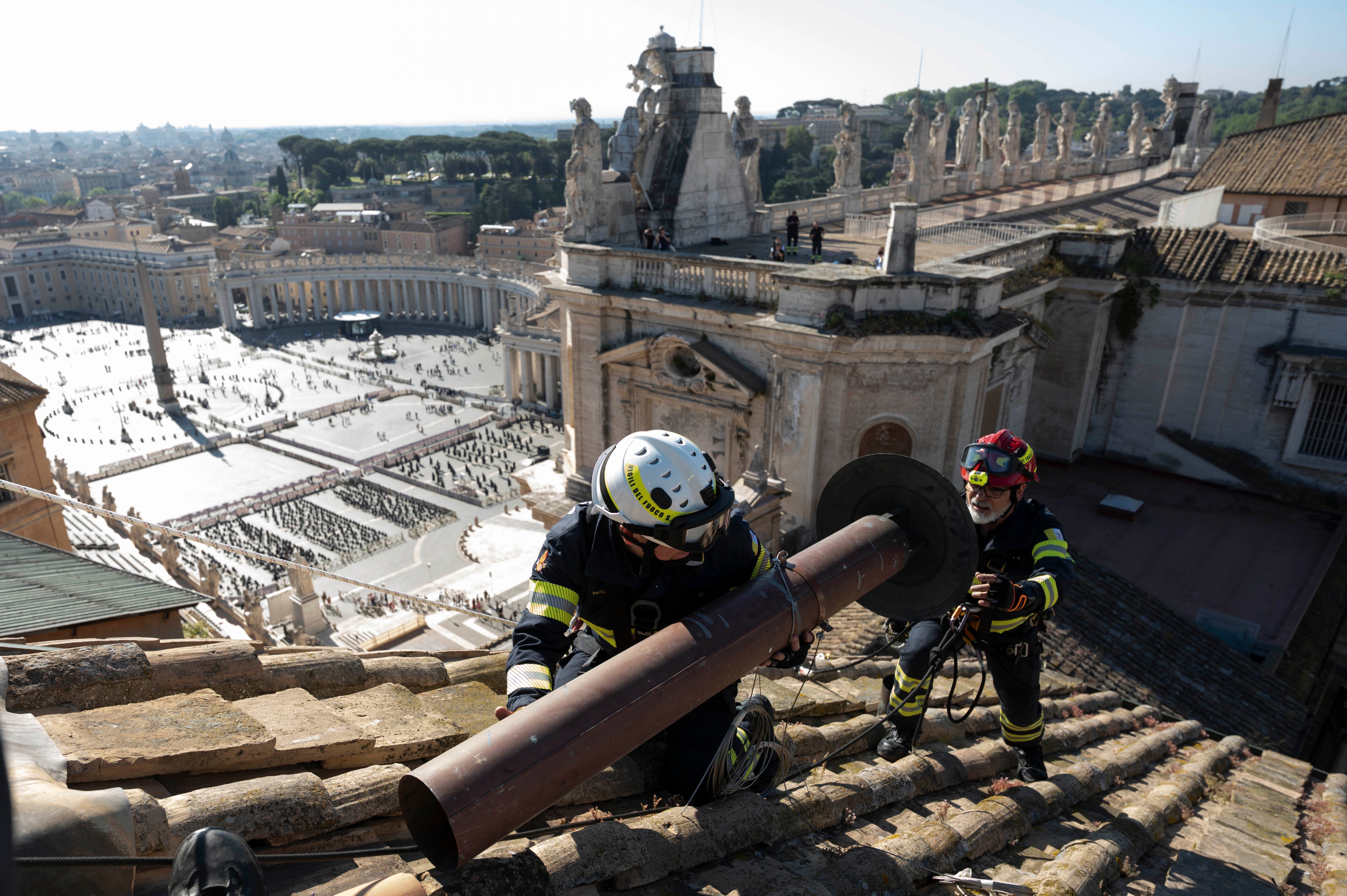 Vatican firefighters install chimney on the roof of the Sistine Chapel