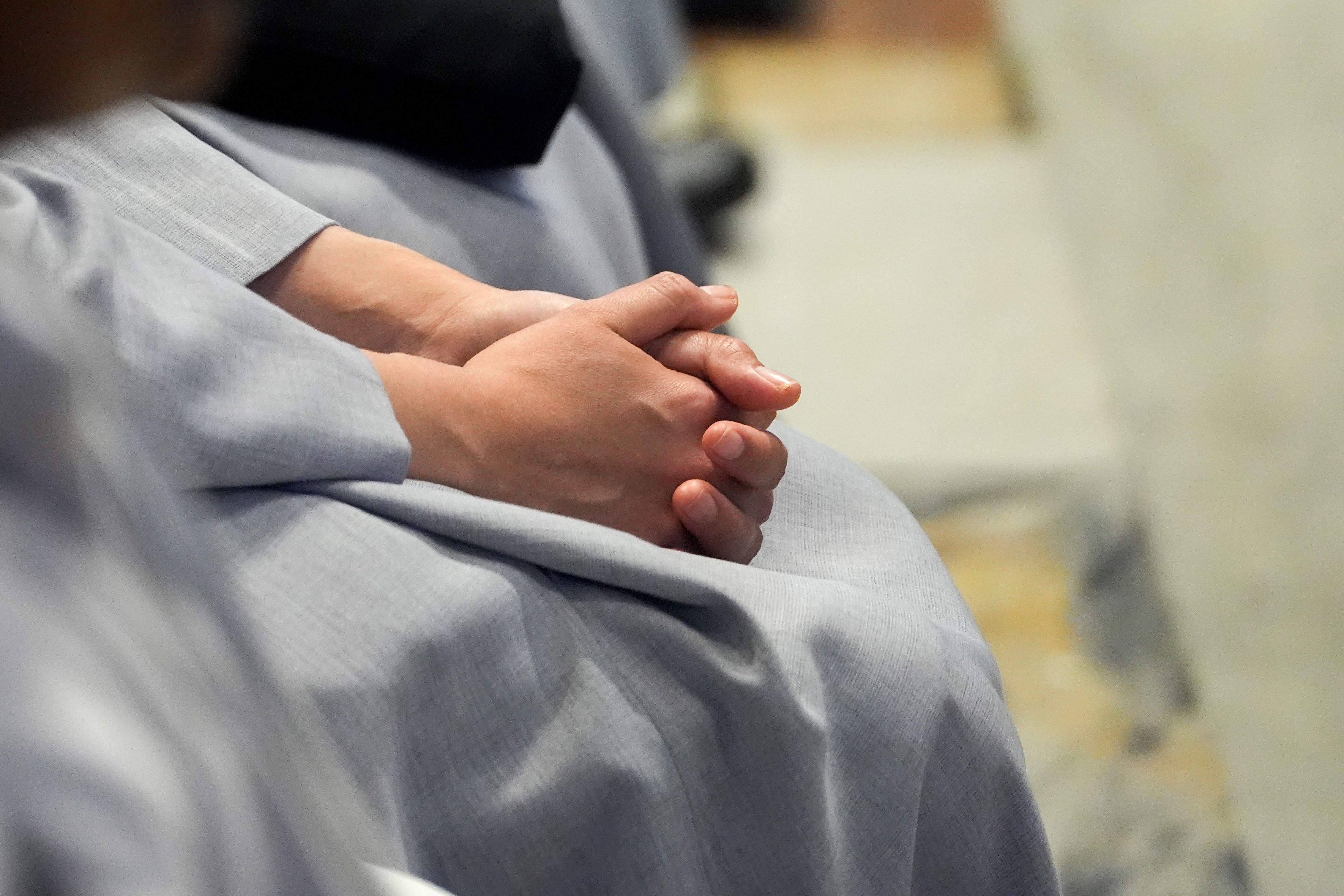 A religious sister prays at memorial Mass