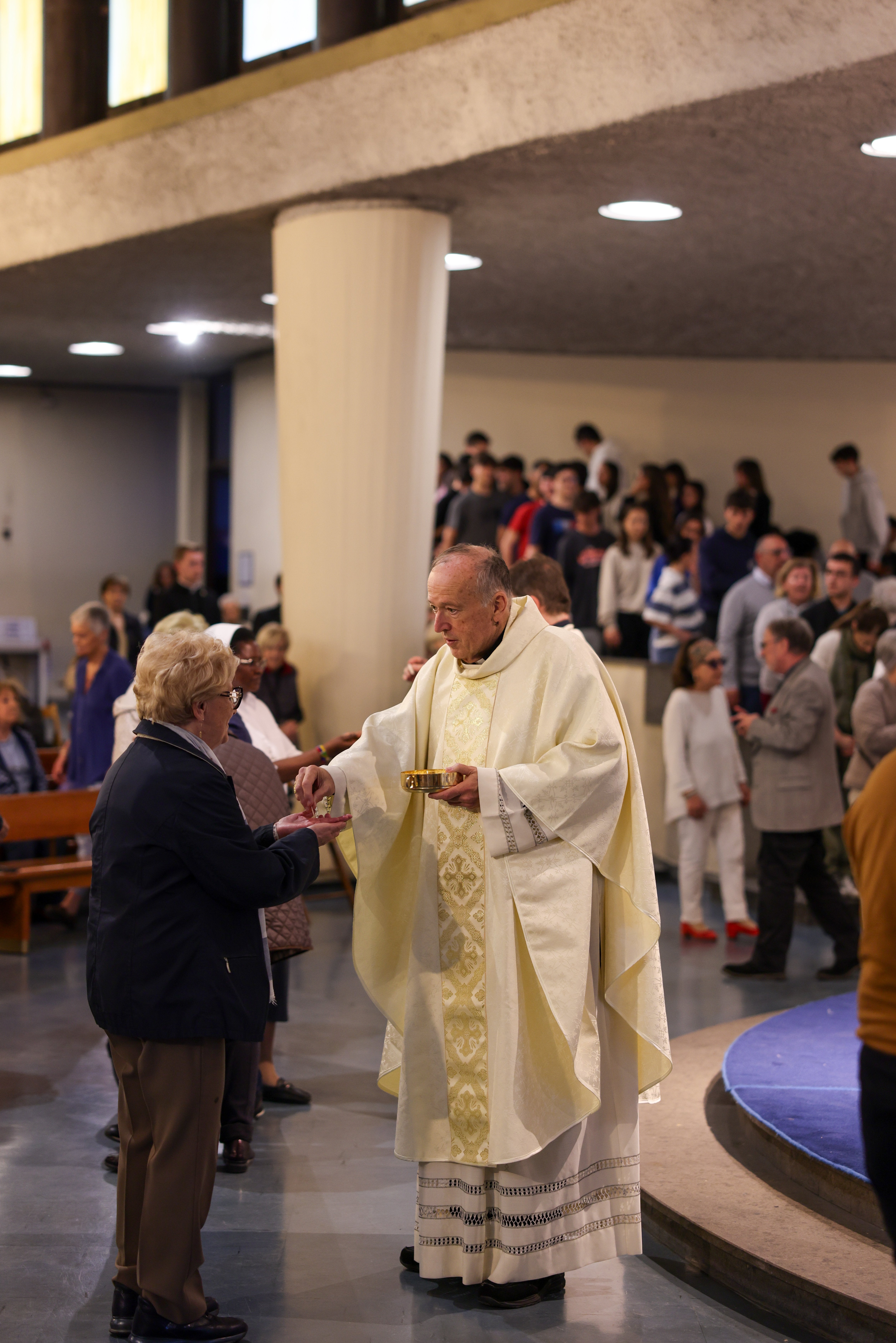 Cardinal McElroy distributes Communion