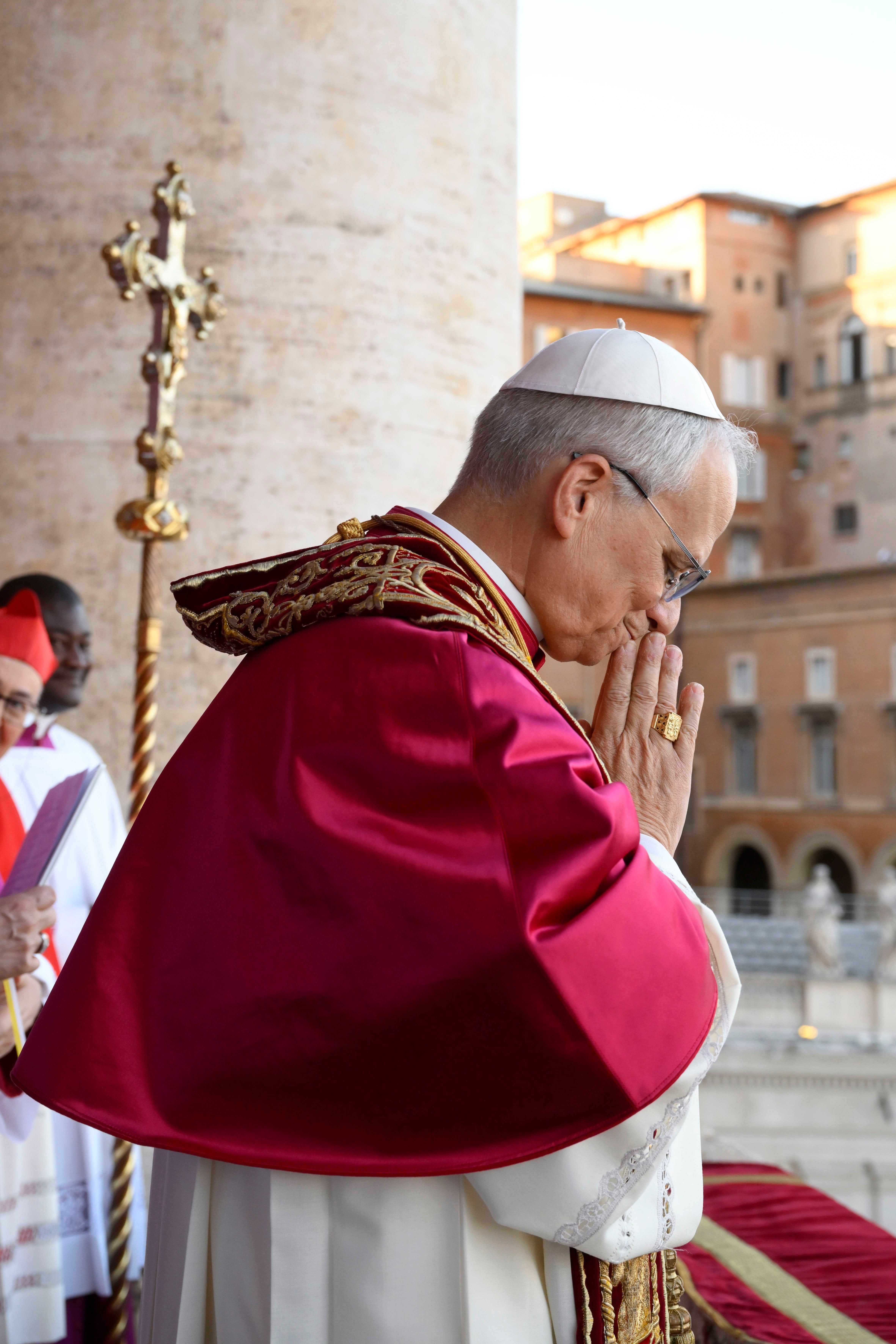 Pope Leo XIV prays on balcony of St. Peter's Basilica