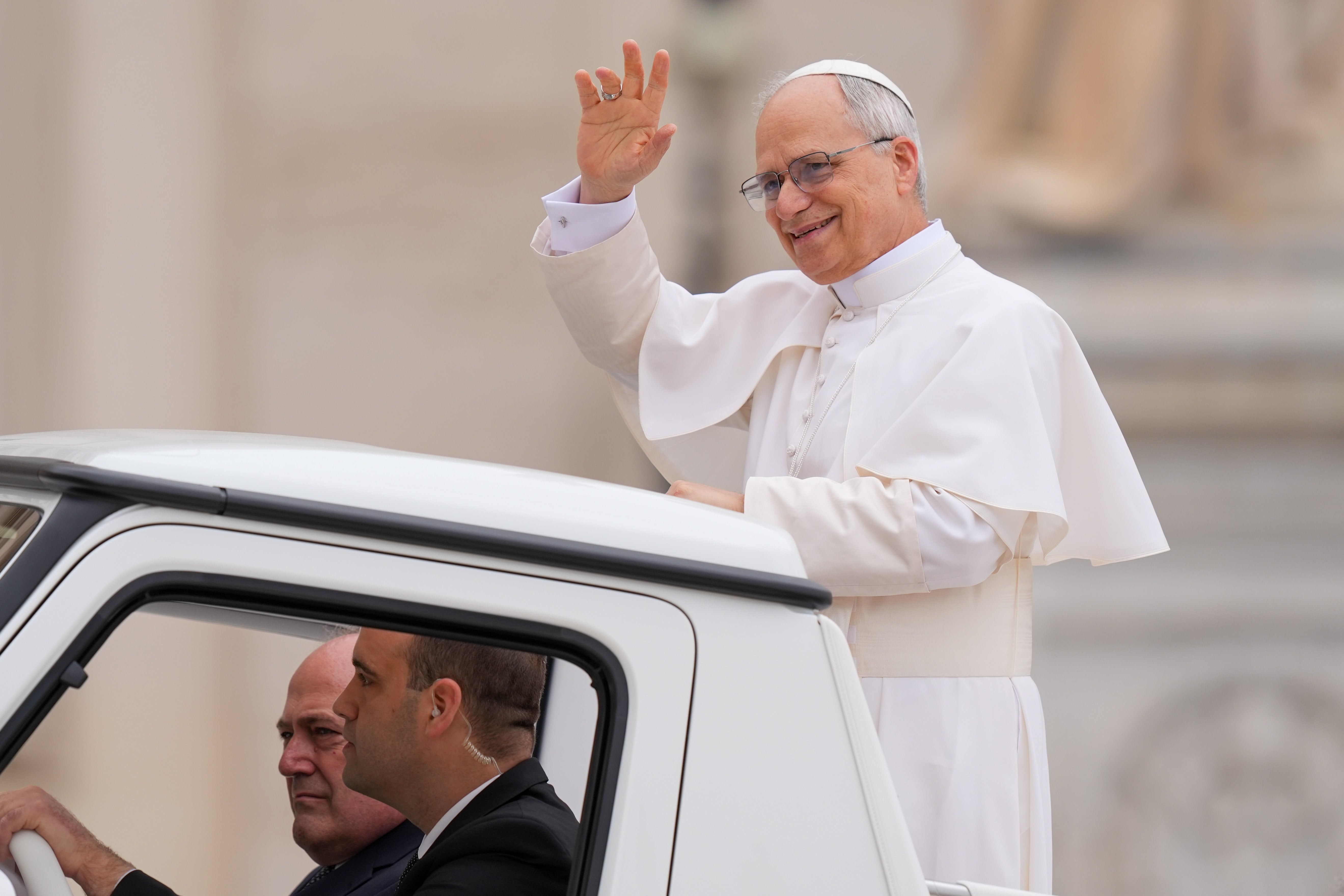 Pope Leo XIV waves from the popemobile