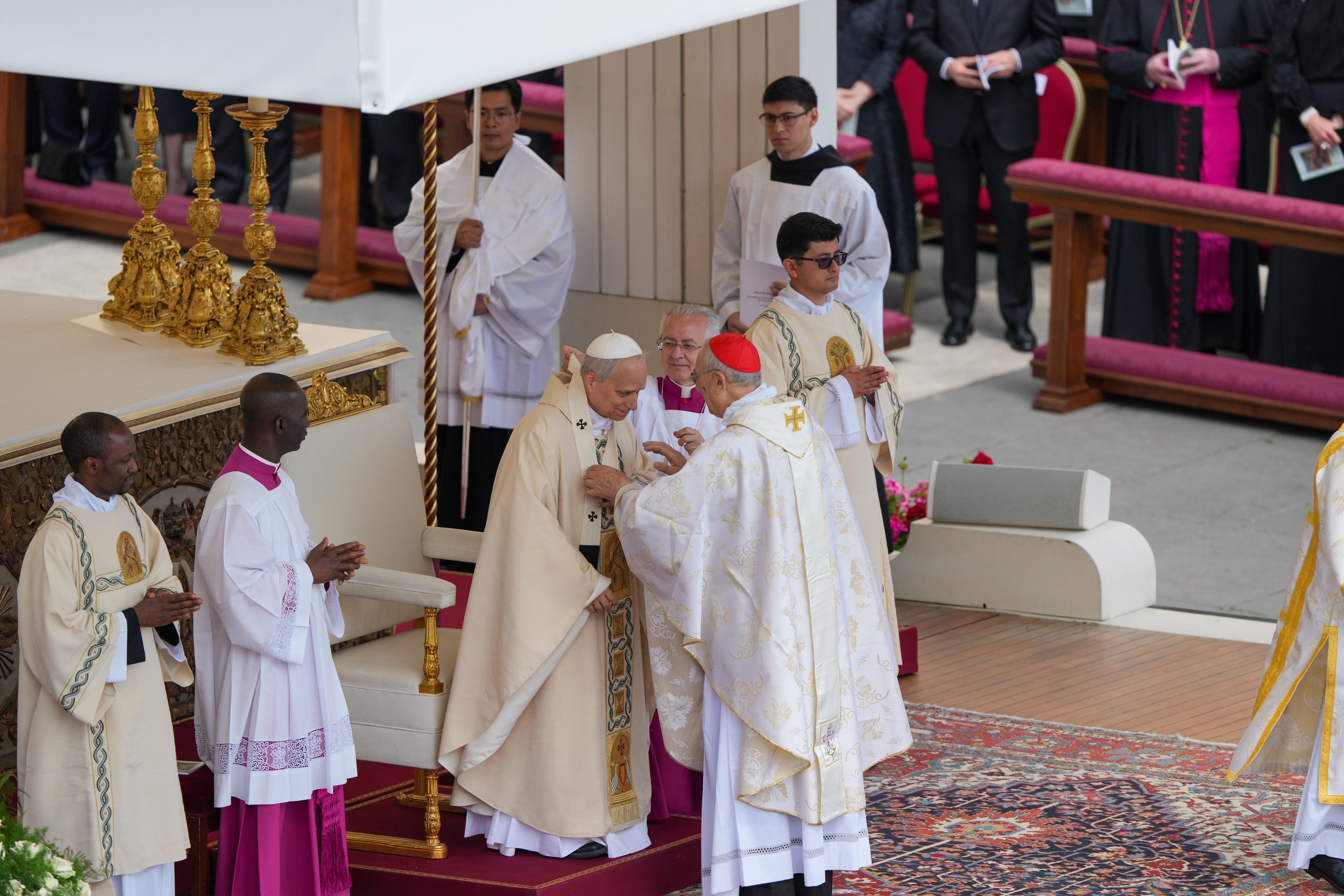 Pope Leo XIV receives a pallium, a woolen band symbolizing his role a shepherd of the universal church.