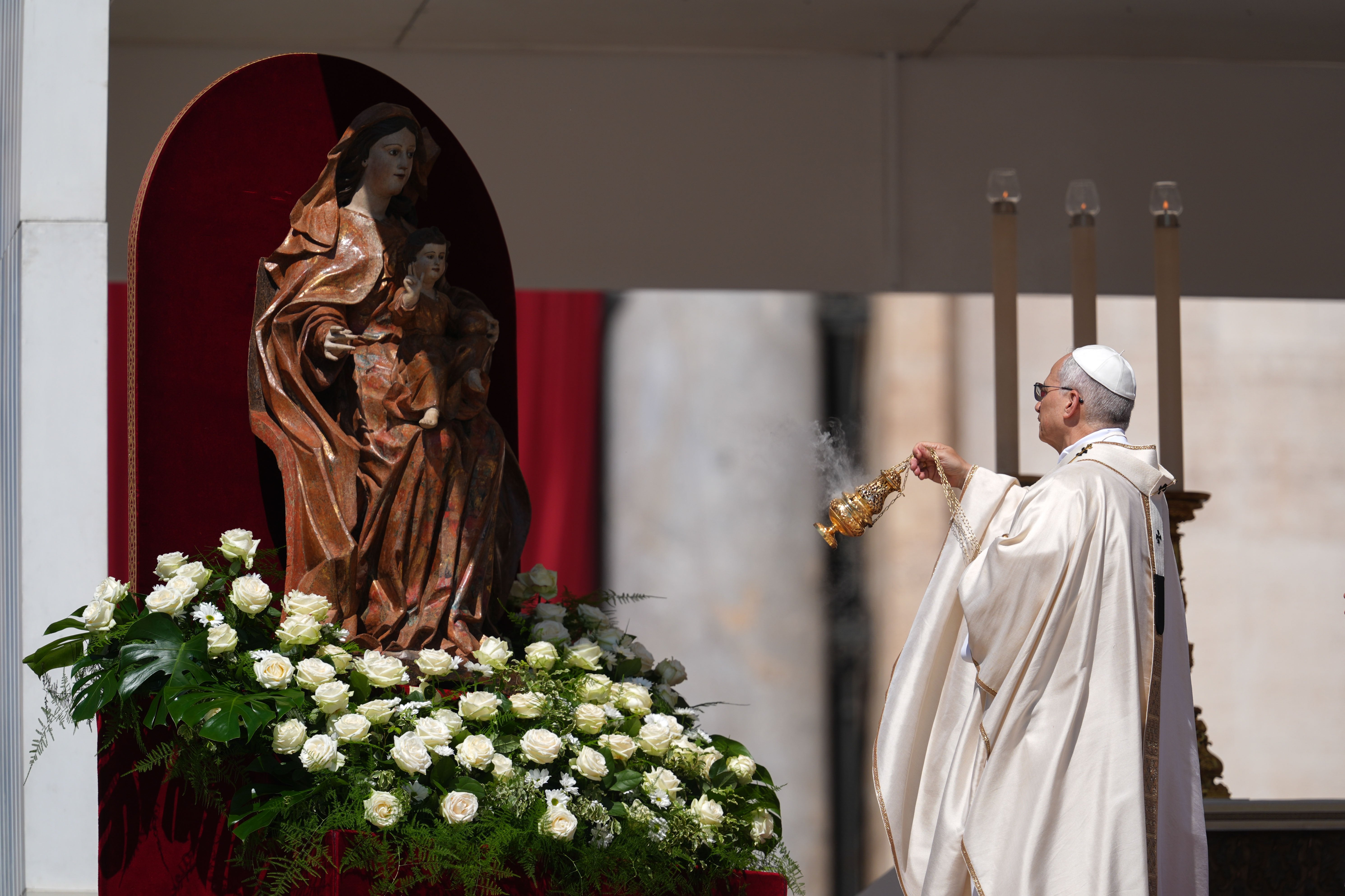 Pope Leo XIV blesses a statue of Mary and Jesus