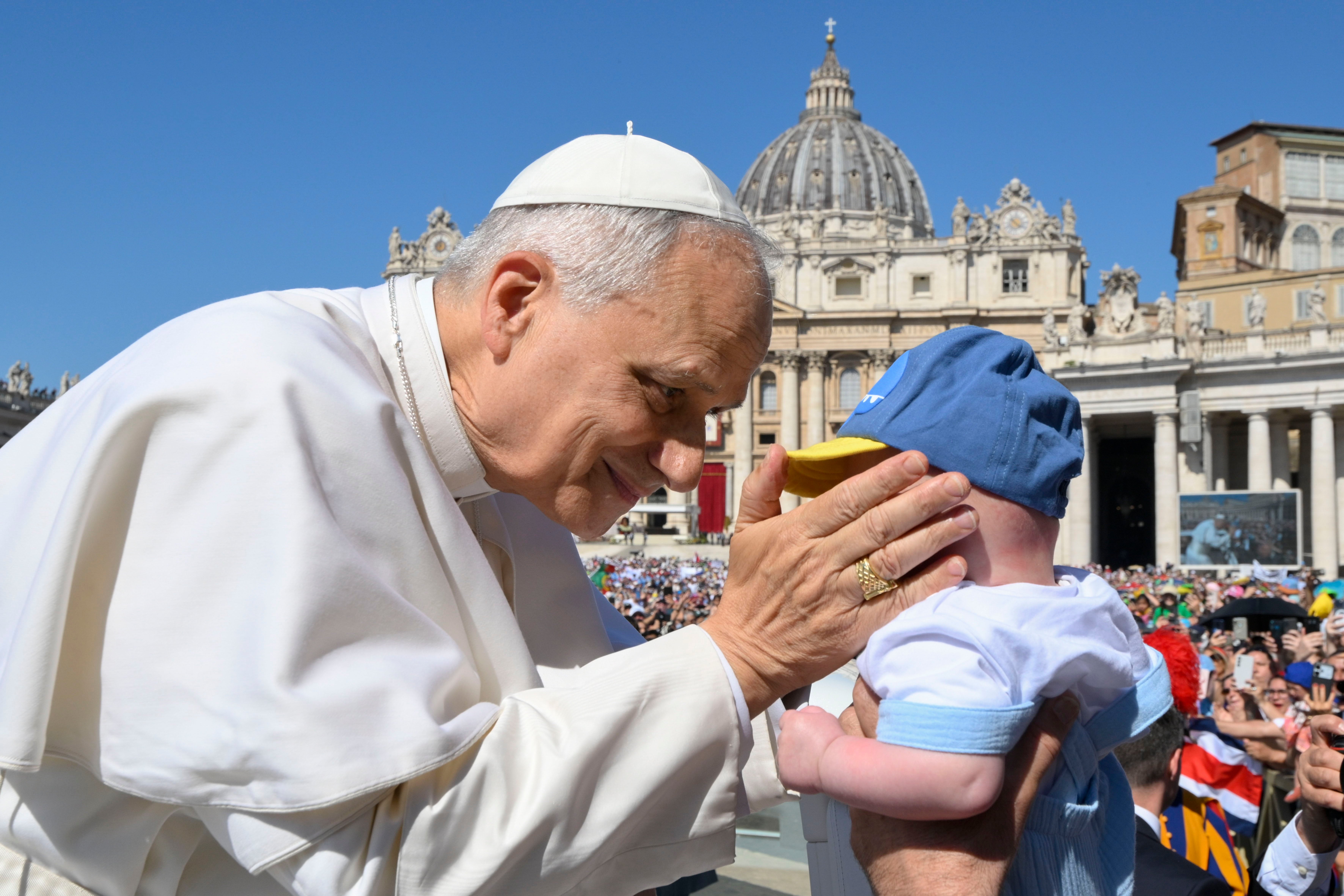 Pope Leo XIV blesses a child