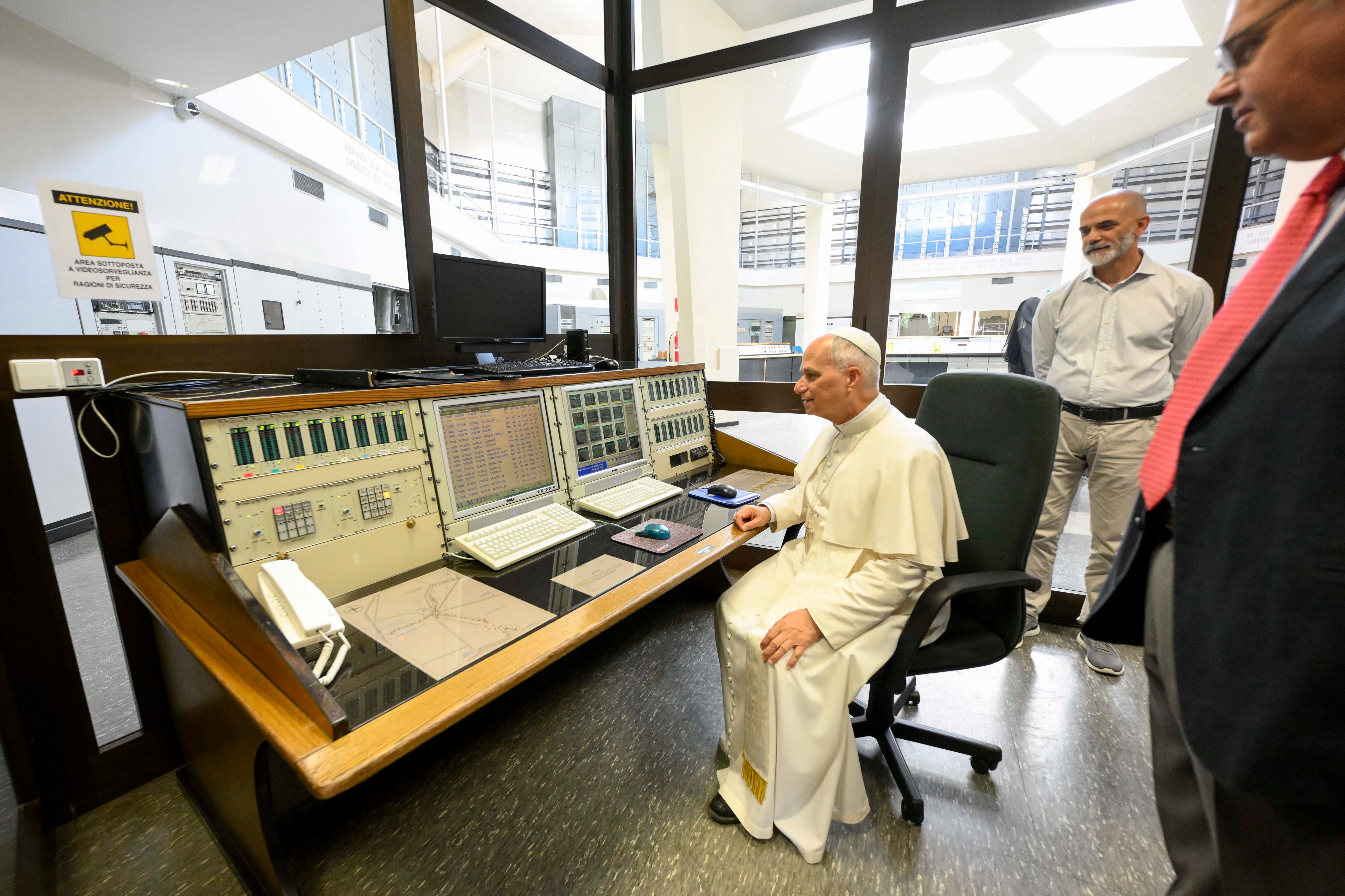 Pope Leo sits at a Vatican Radio control panel