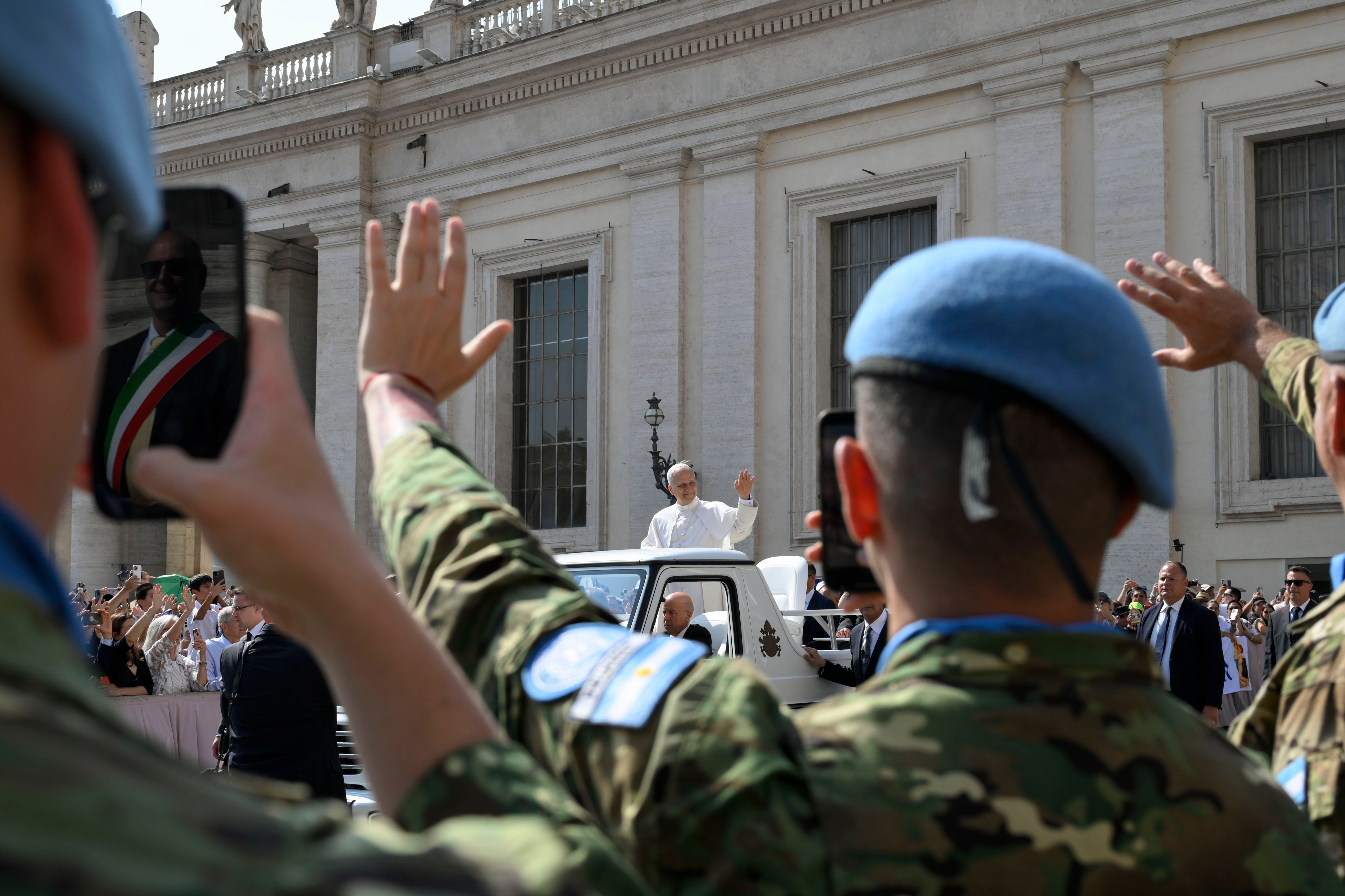 Pope Leo XIV waves to a delegation of UN peacekeepers.