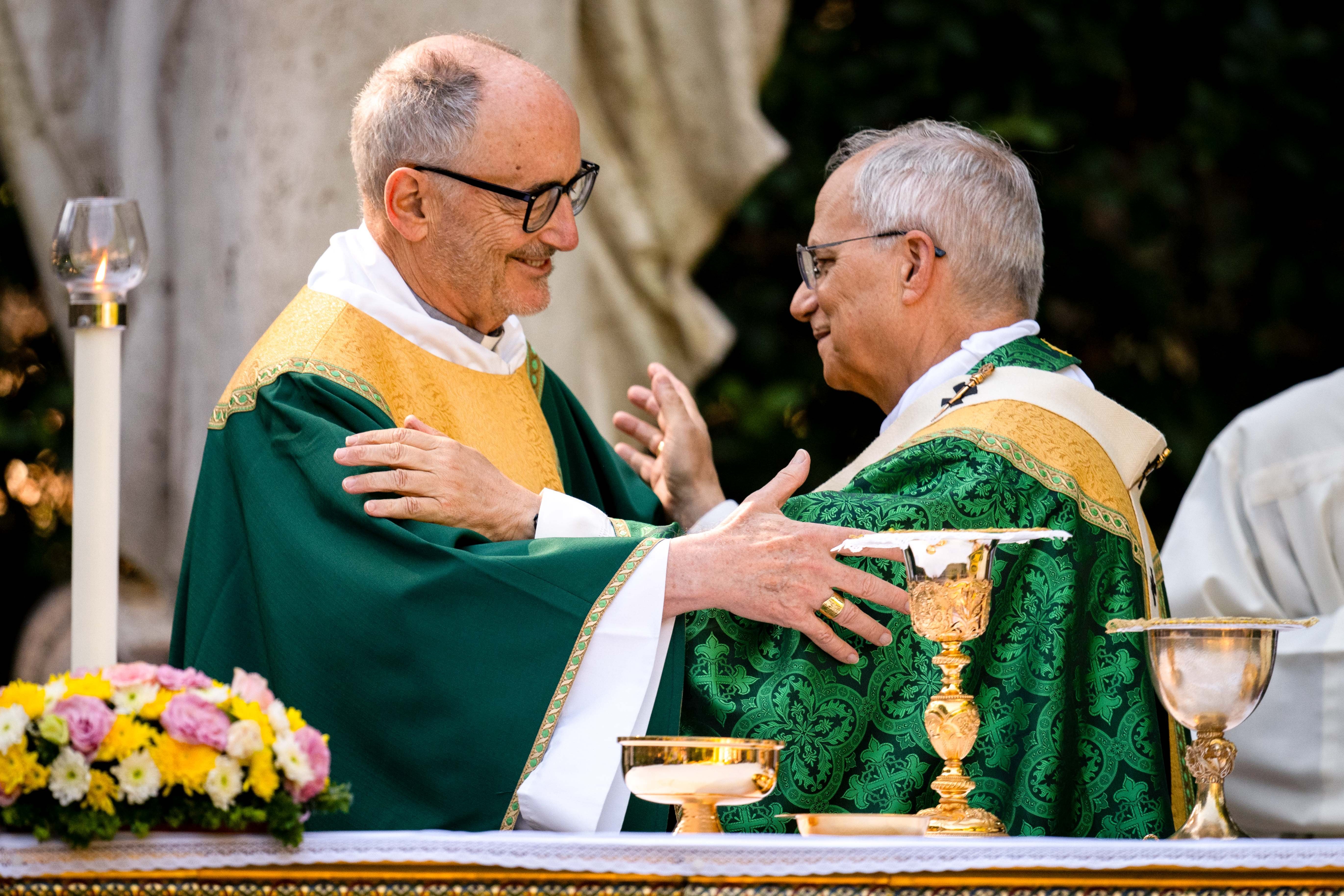 Pope Leo XIV exchanges a sign of peace with Cardinal Michael Czerny, prefect of the Dicastery for Promoting Integral Human Development.