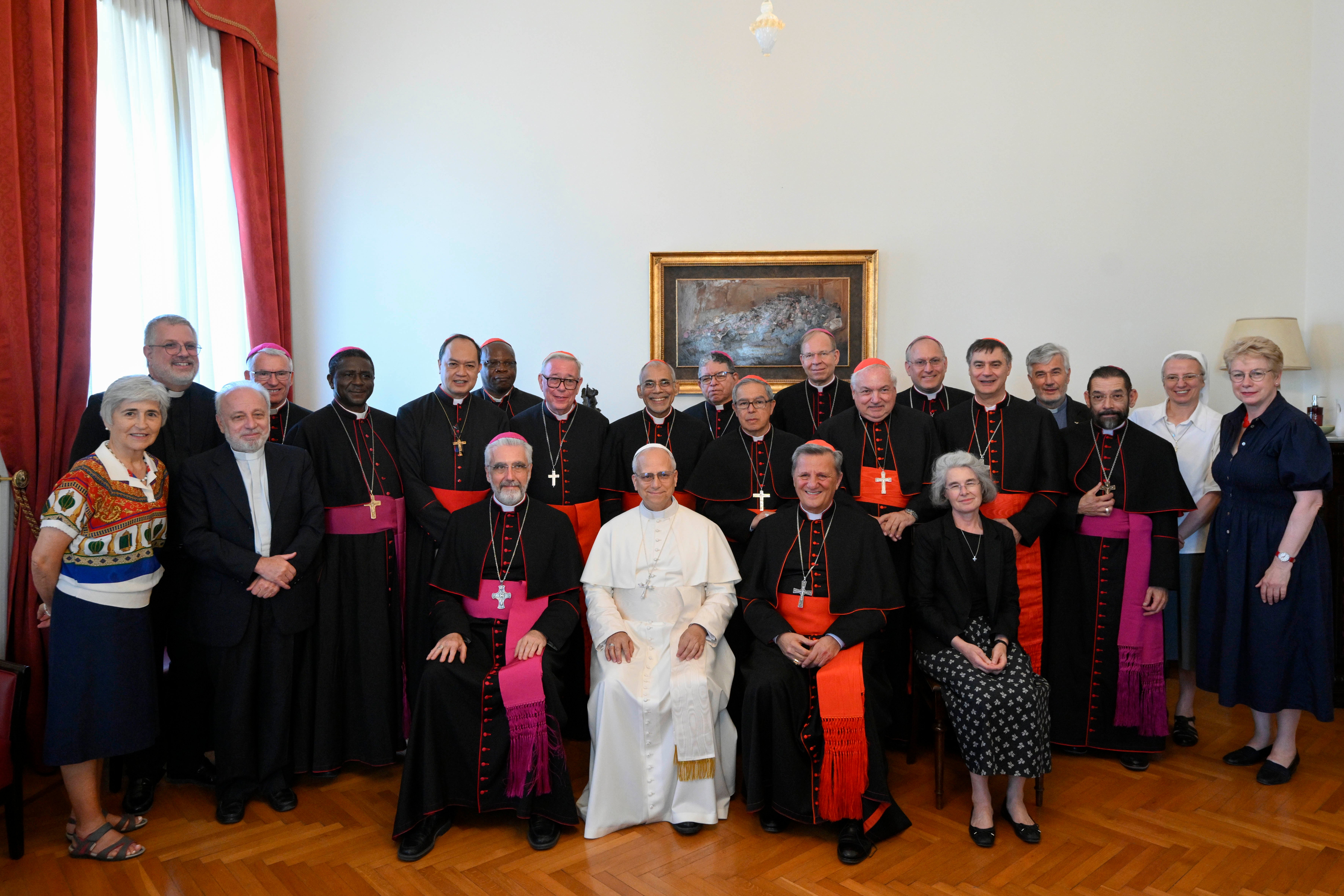 Pope Leo XIV poses for a photo with the Ordinary Council of the General Secretariat of the Synod.