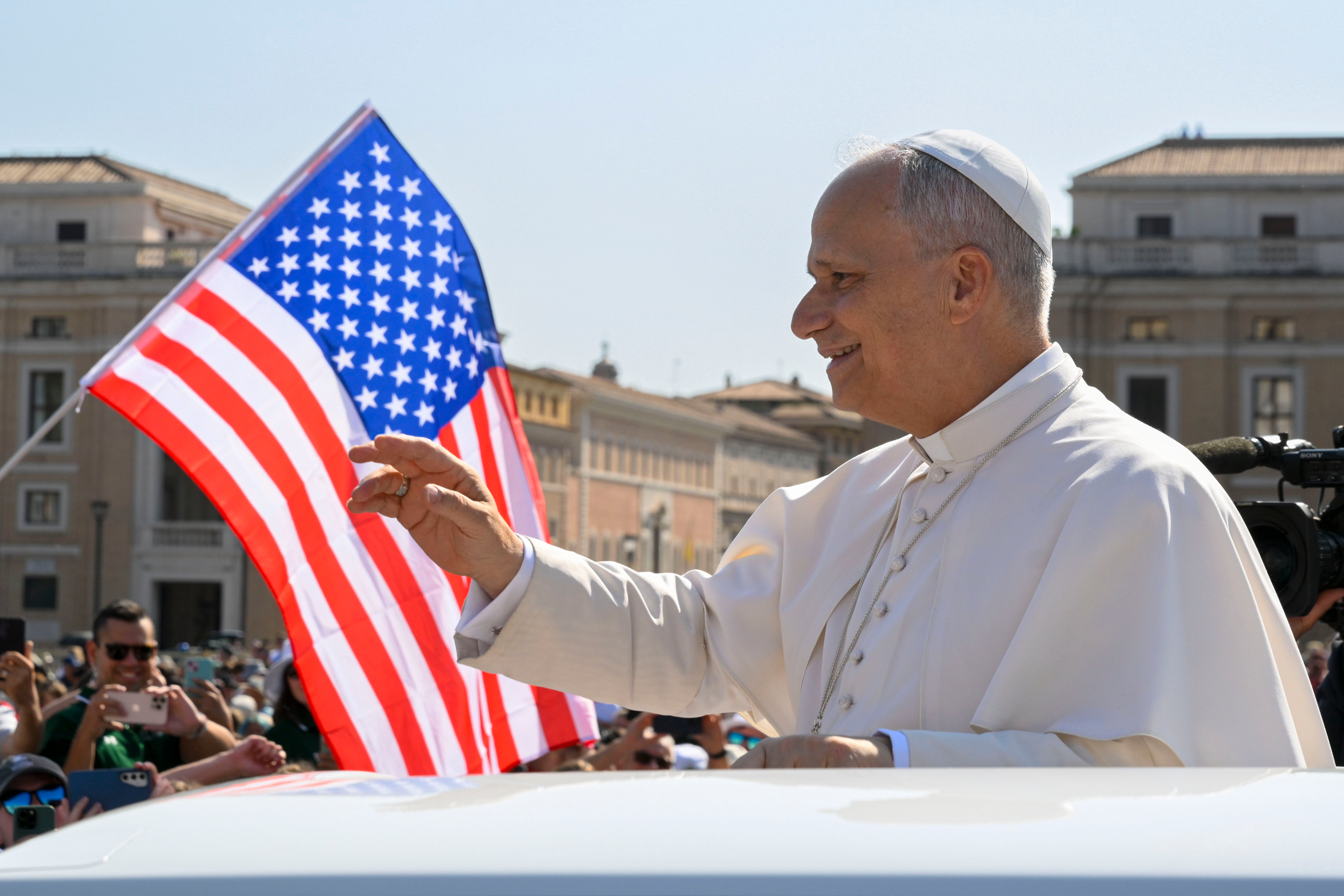 Pope Leo XIV waves from the popemobile