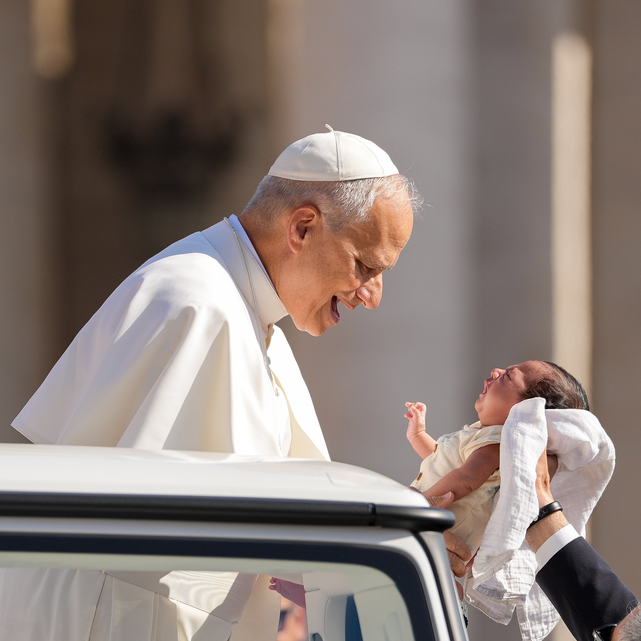 Pope Leo XIV blesses a baby