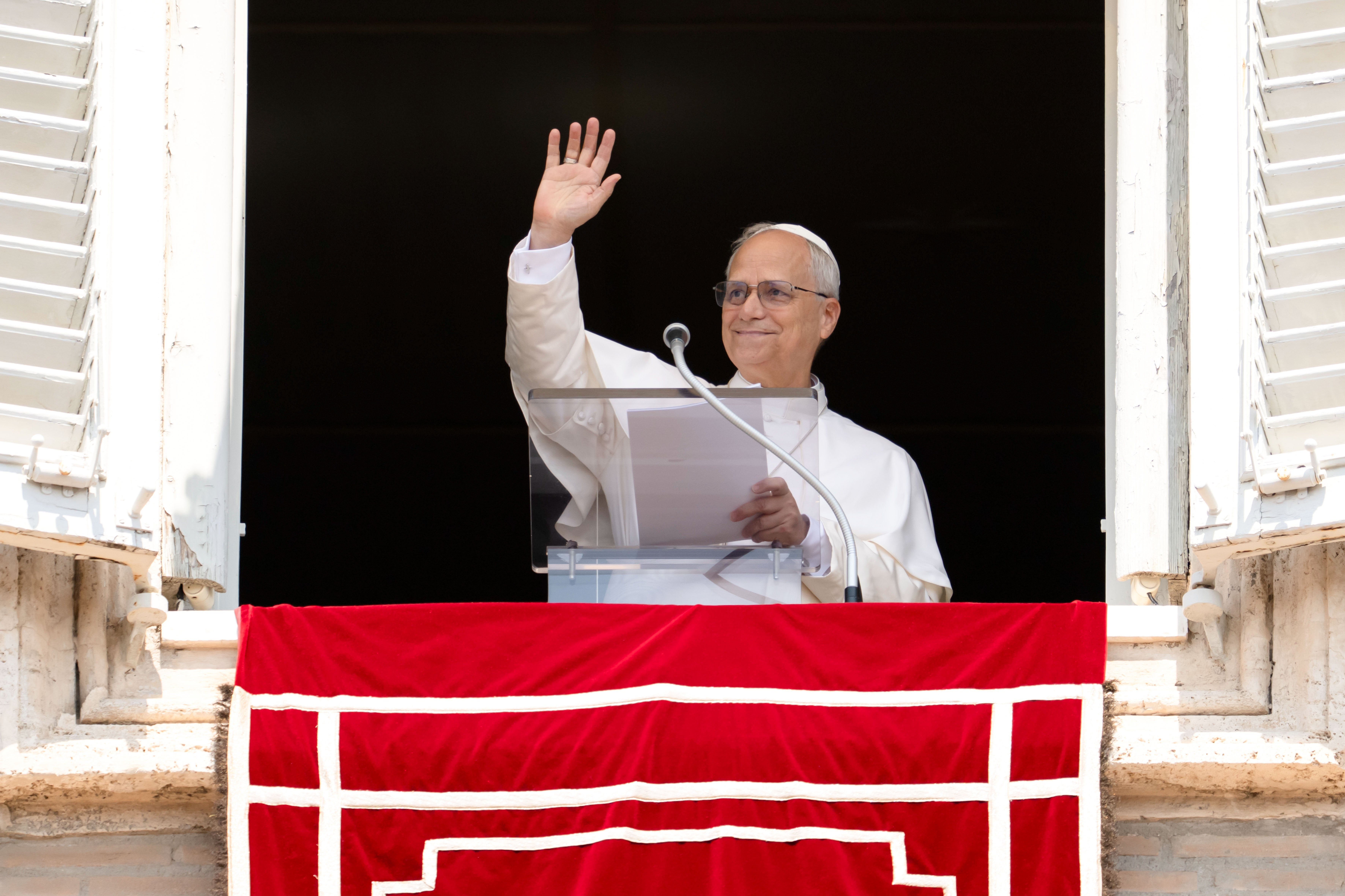 Pope Leo XIV waves to a crowd in St. Peter's Square