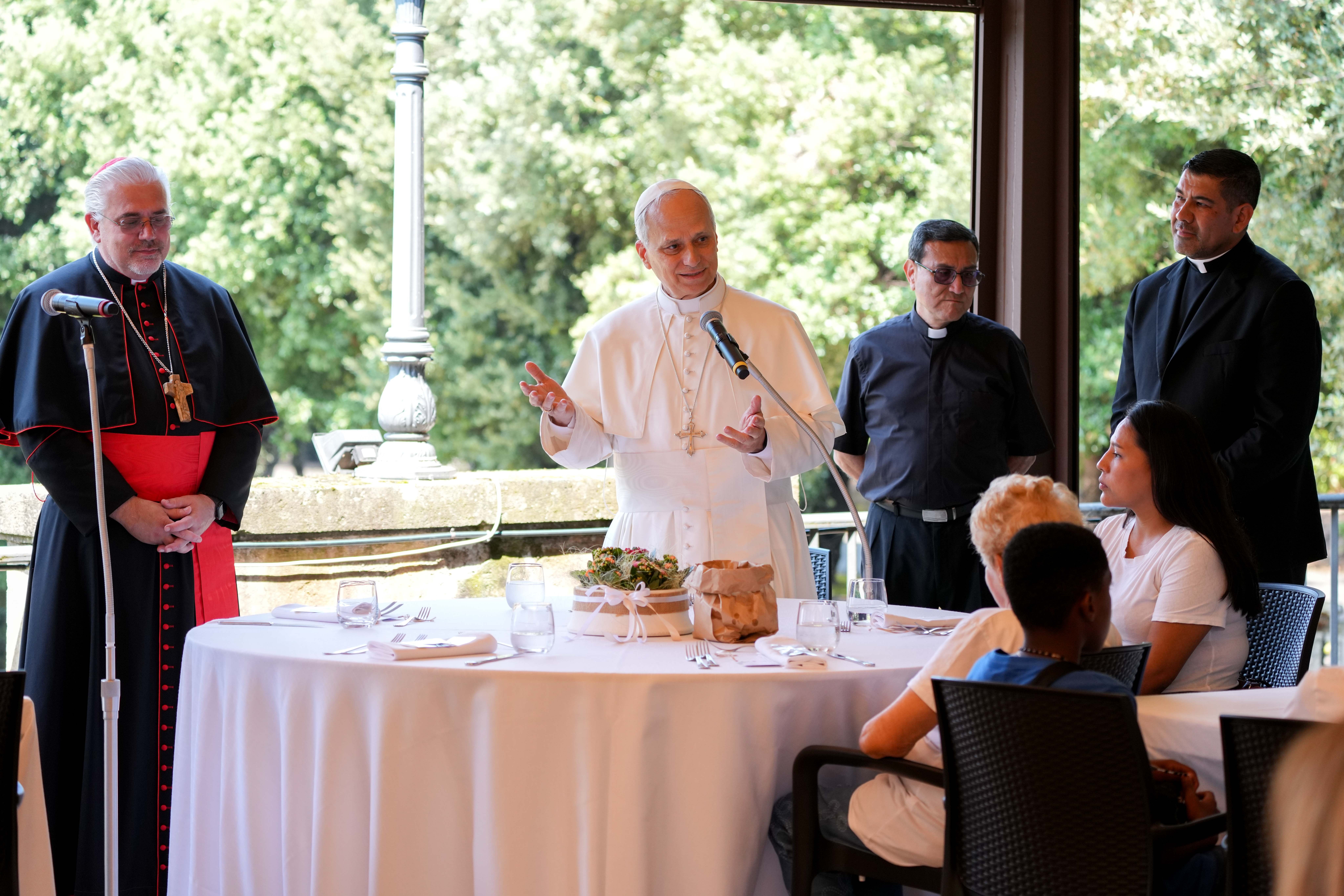 Pope Leo XIV speaks to his lunch guests