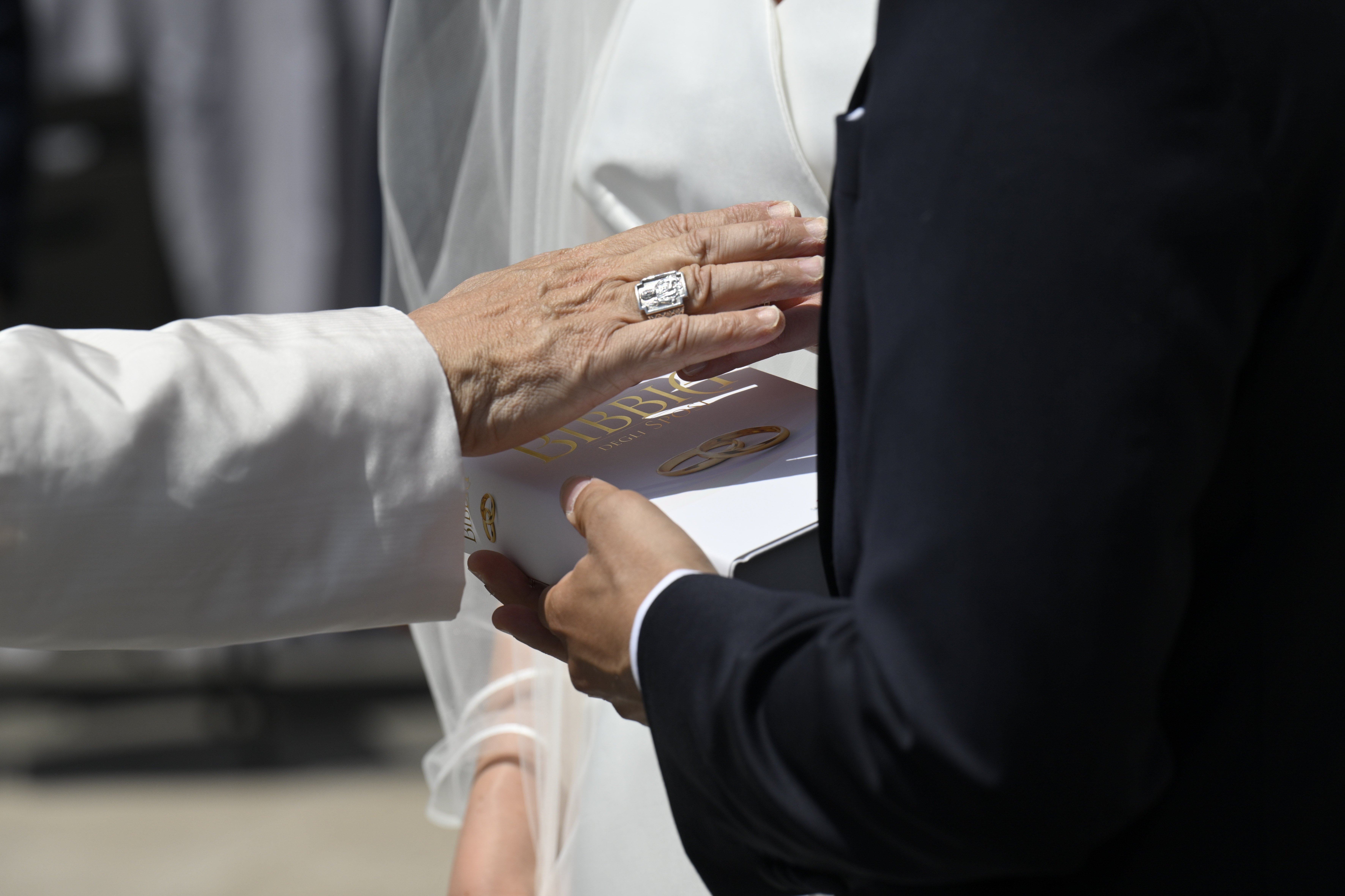 Pope Leo blesses a Bible for newlyweds