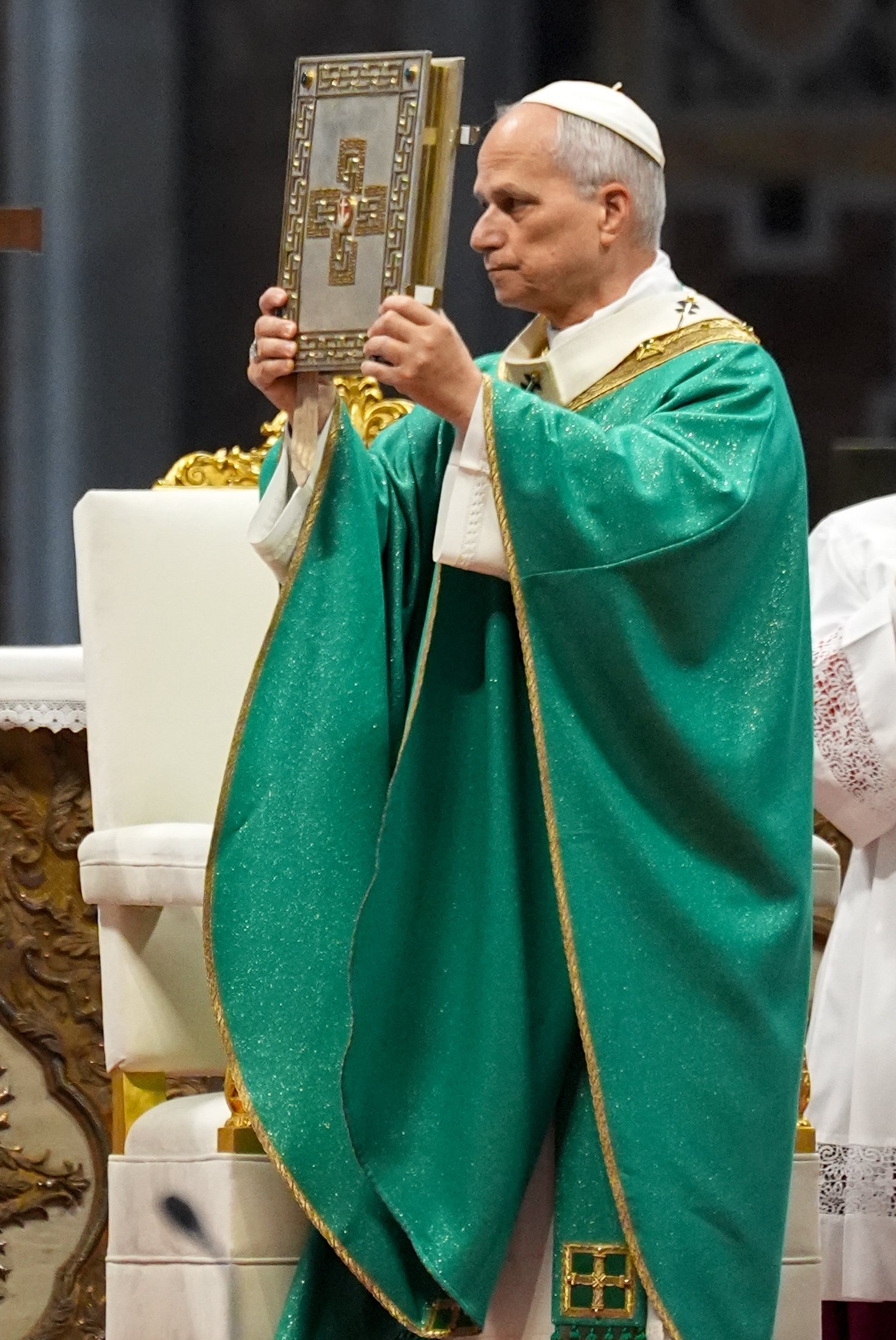 Pope Leo holds the Book of the Gospels