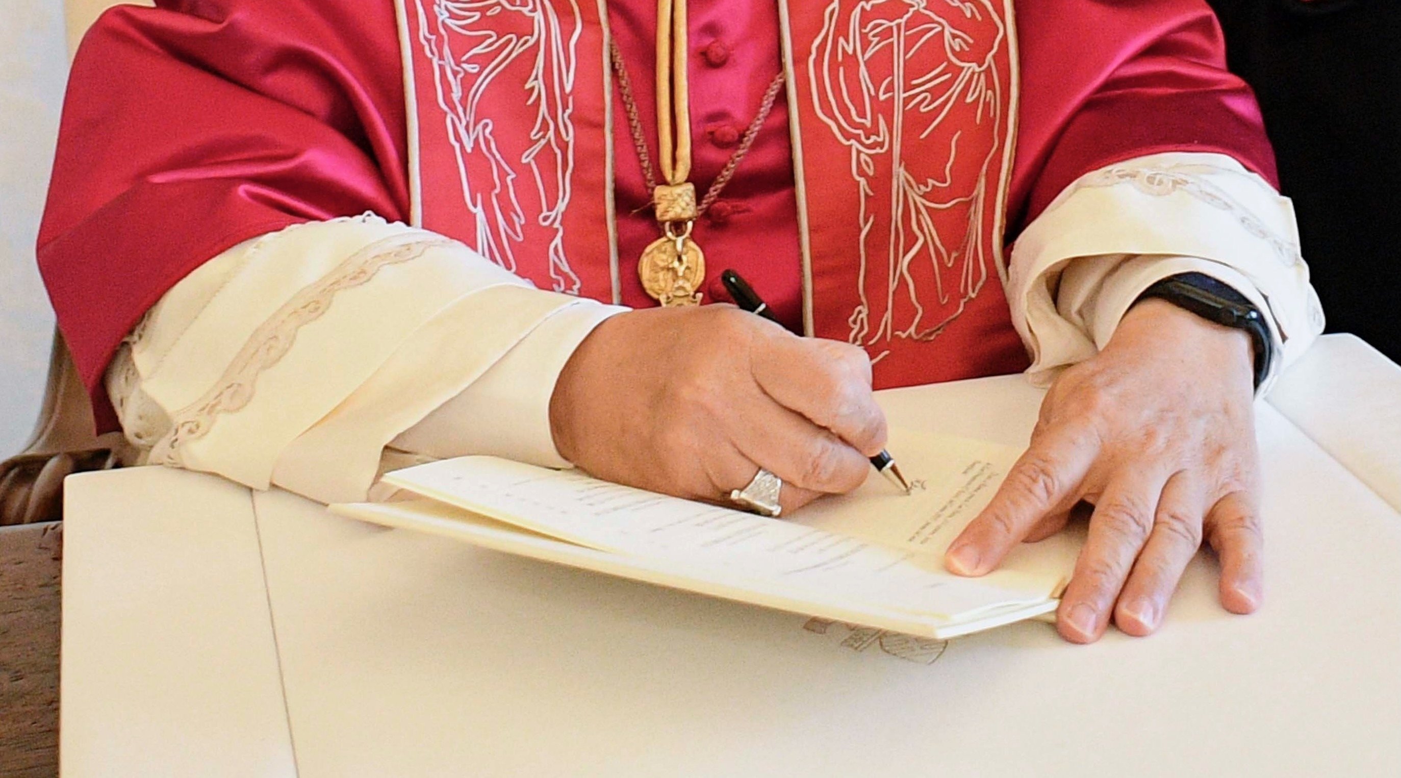 Pope Leo XIV signs a document