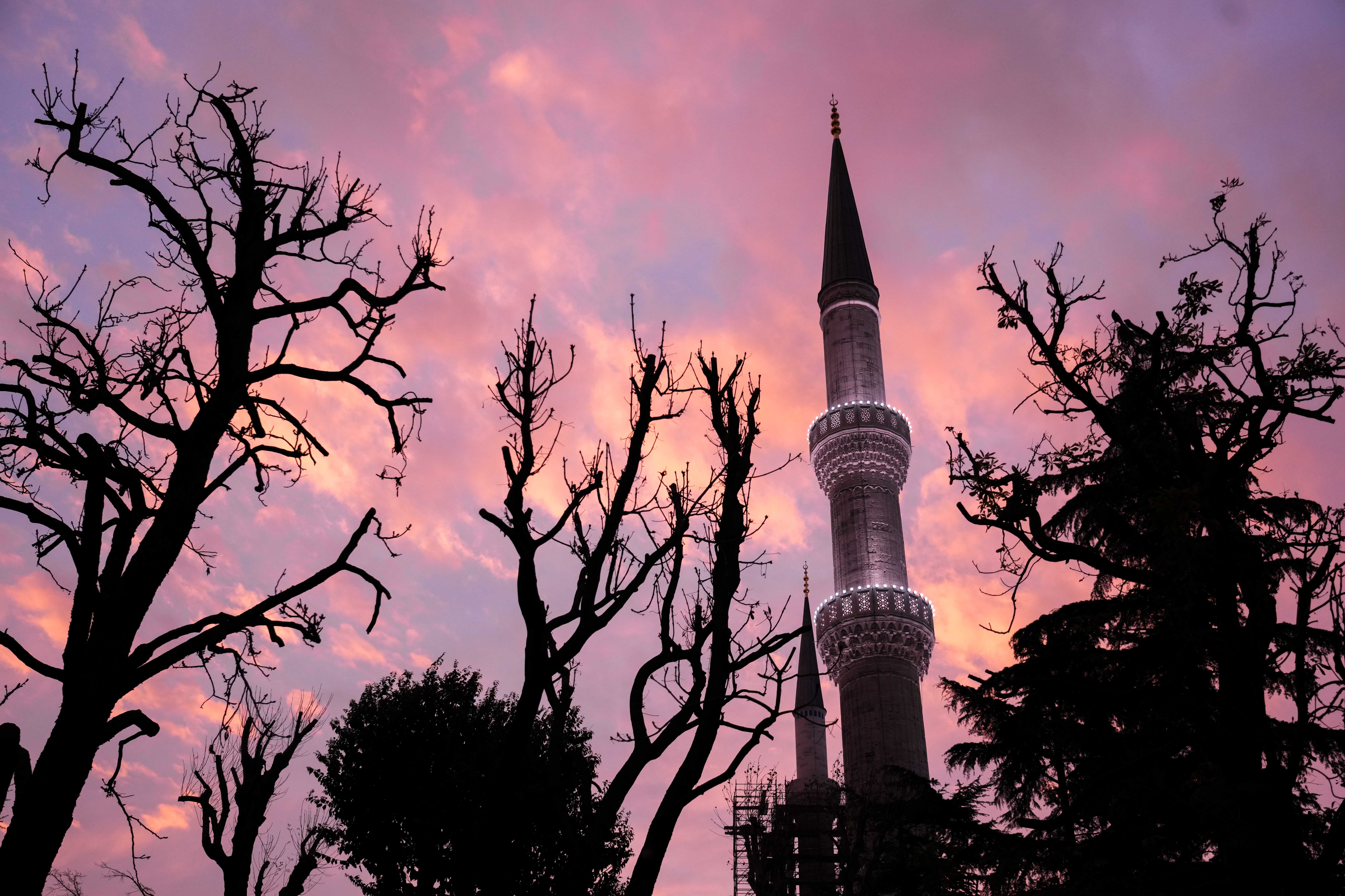 A minaret of the Blue Mosque at sunrise