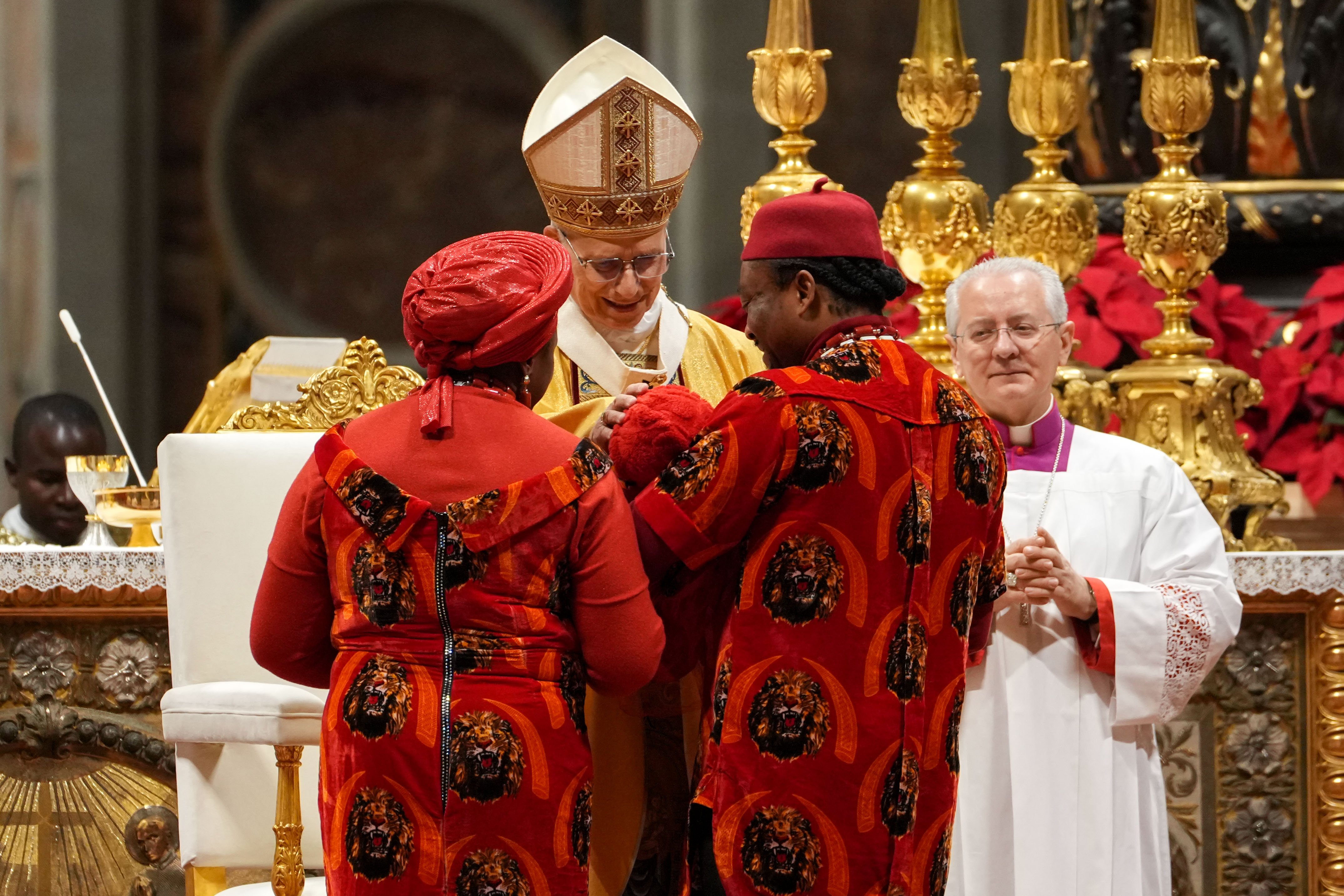 Pope Leo blesses a child on Christmas Eve
