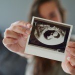 Mom holding ultrasound photo