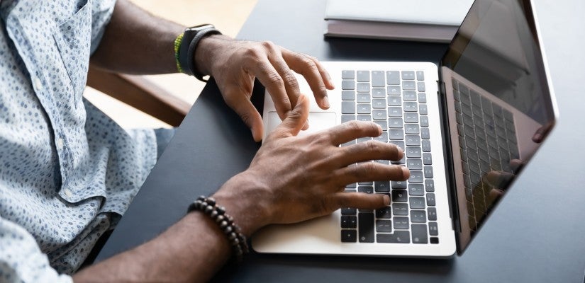 Man typing on a laptop