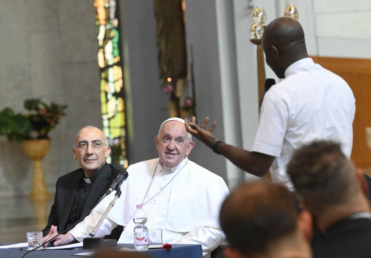 Pope Francis listens to a question during a meeting with priests ministering