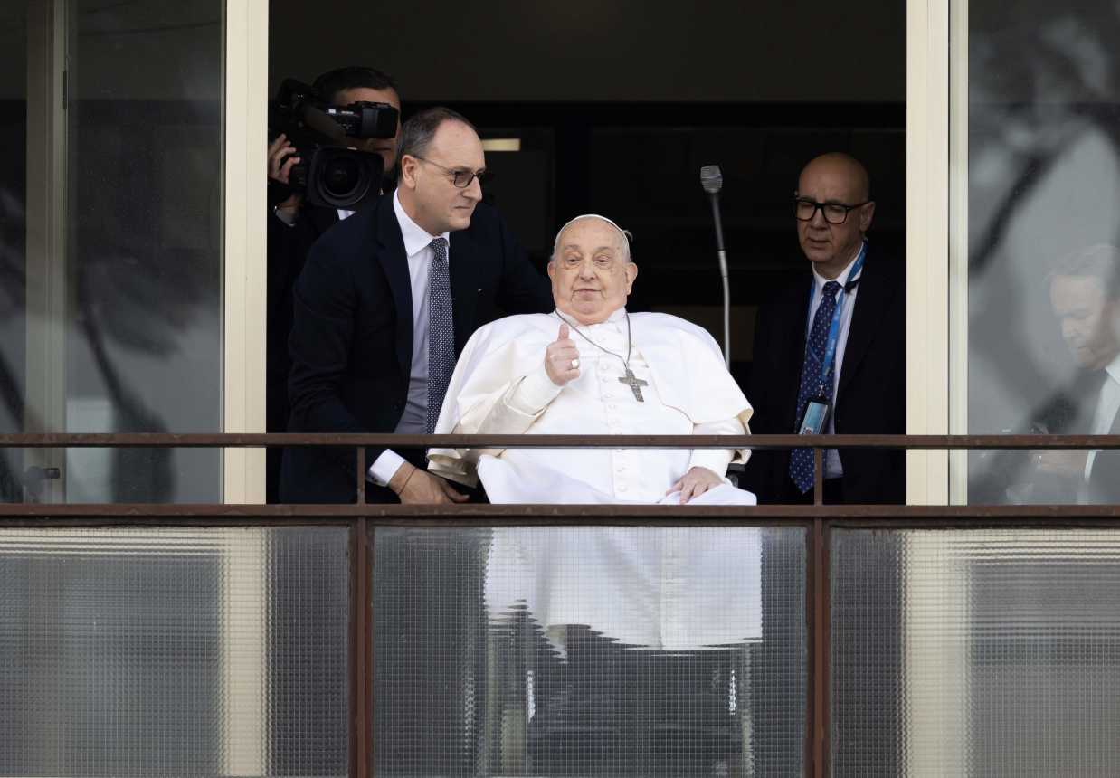 Pope Francis gives a thumbs up to the crowd at Gemelli hospital