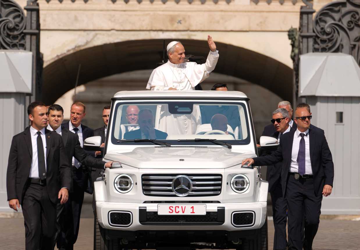 Pope Leo XIV waves from the popemobile