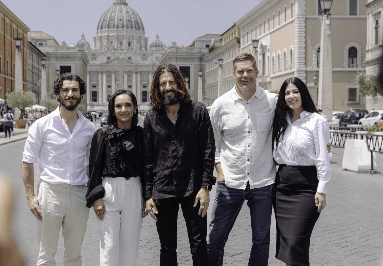 Members of the cast and crew of the series, "The Chosen," pose for a picture in front of St. Peter's Basilica.