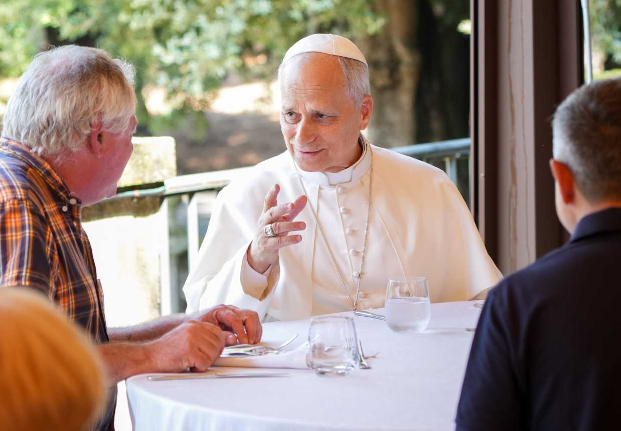 Pope Leo XIV speaks to his lunch guests