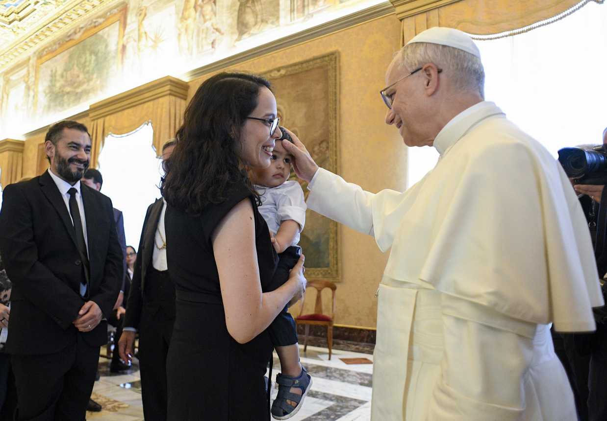 Pope Leo XIV blesses a child