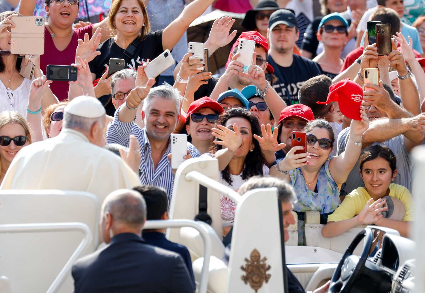Pope Francis waves to visitors from the popemobile.