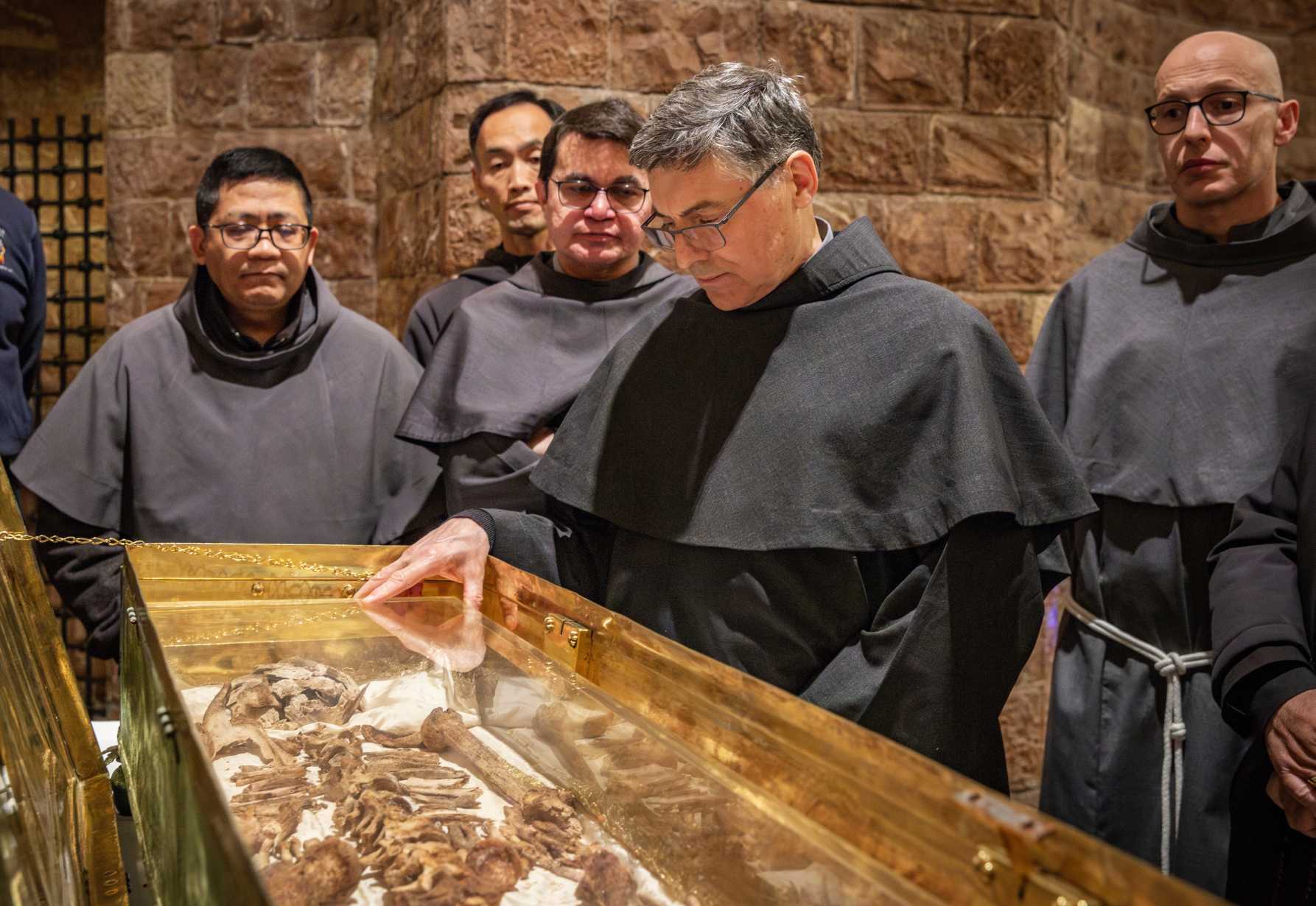 Why do the bones of St. Francis draw hundreds of thousands of pilgrims?