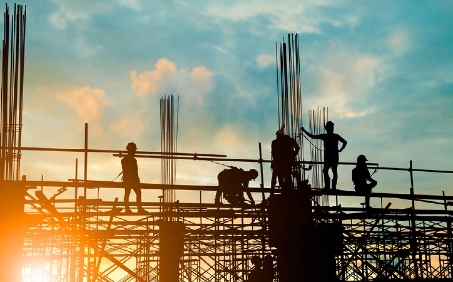 Silhouette of engineer and construction team working safely on scaffolding on high rise building. over blurred background sunset pastel for industry background with Light fair