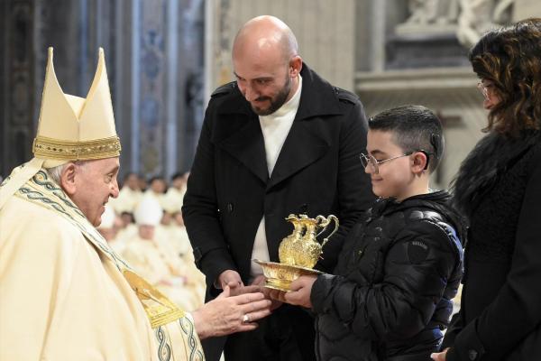 Pope Francis receives the offeratory gifts at Mass Jan. 1.