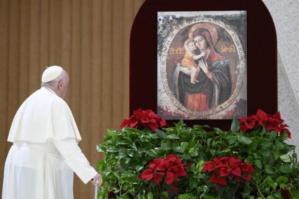 Pope Francis prays at the beginning of his general audience