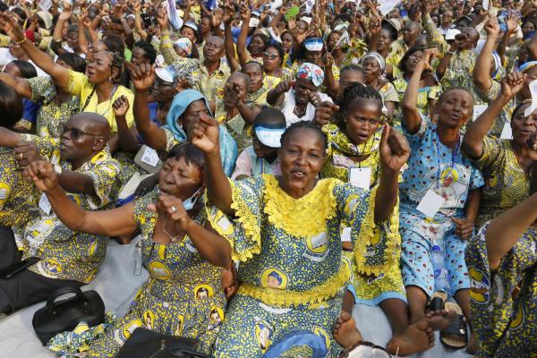 People wait for Pope Francis at a stadium in Kinshasa