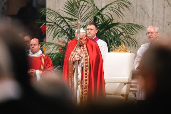 Pope Francis holds his head on his papal ferula.