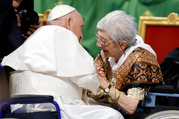 Pope Francis greets an elderly woman. 