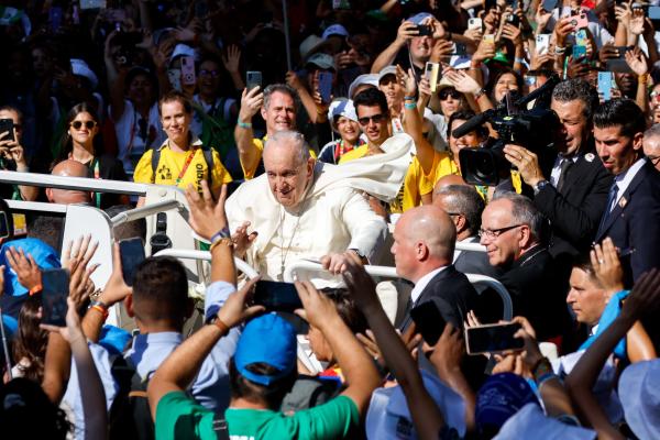 Pope Francis arrives for meeting with young people in the popemobile.