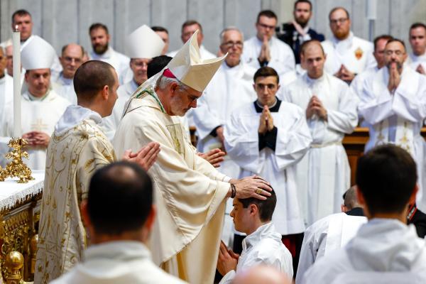 Archbishop Coakley ordains a seminarian to the diaconate. 