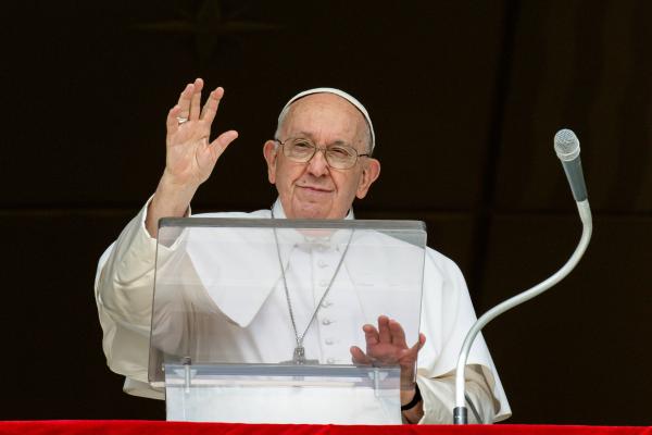 Pope Francis waves to a crowd in St. Peter's Square.