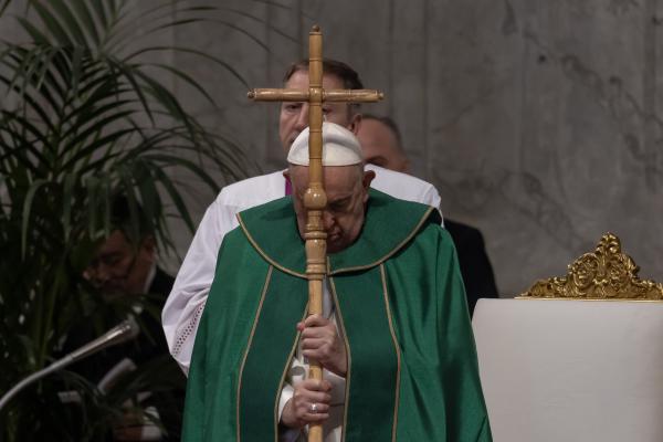 Pope Francis prays at the start of Mass.